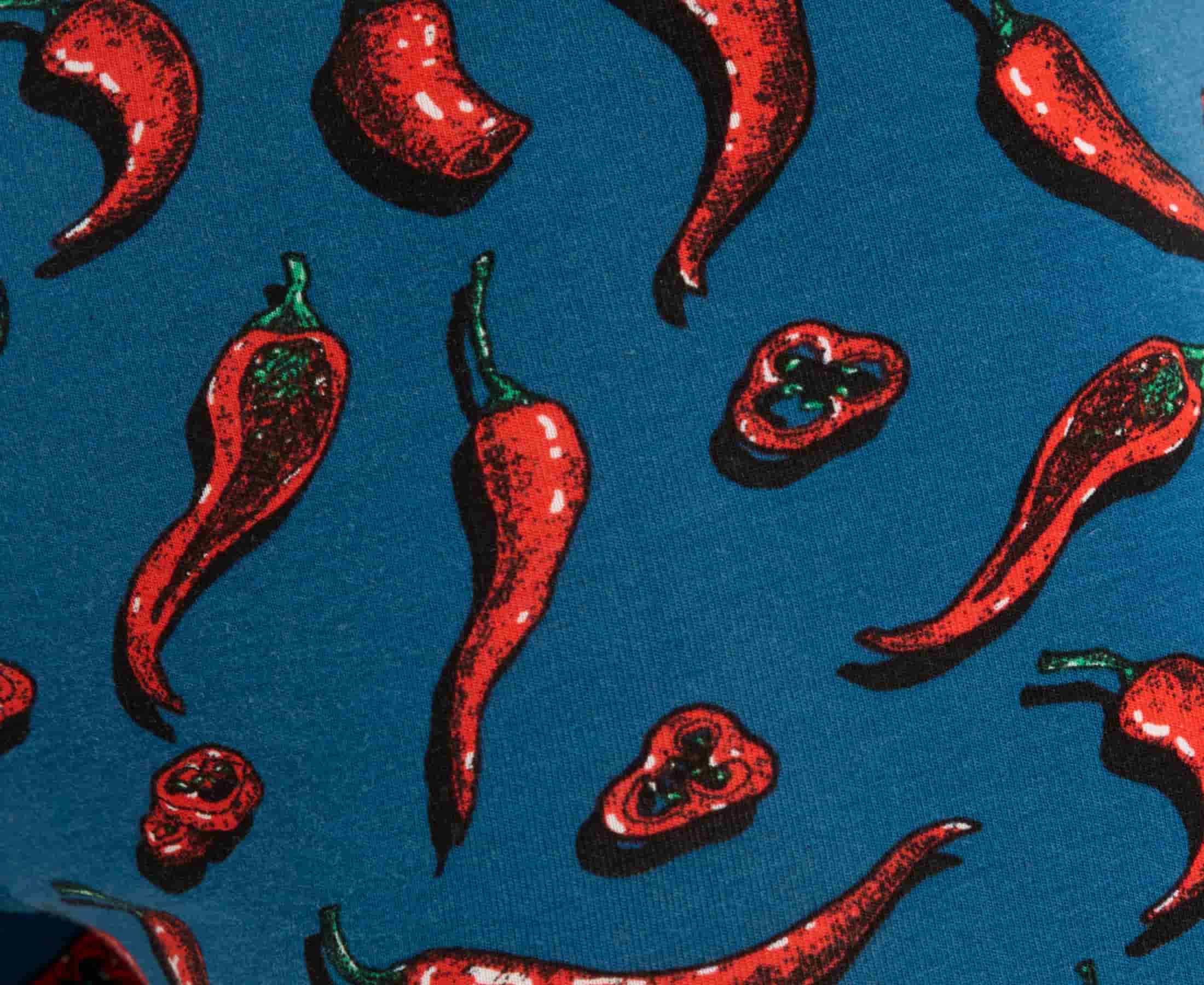 Blue fabric with red chili pepper pattern