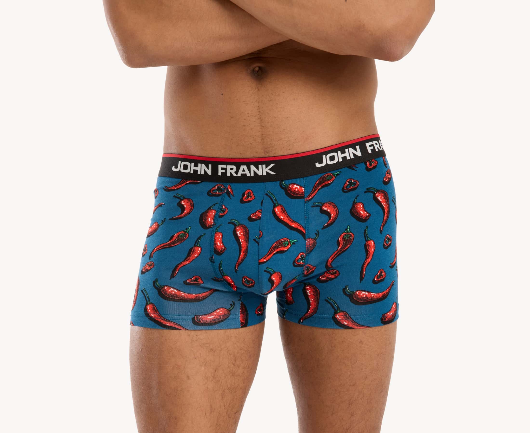Front view of male model wearing men’s 95% cotton boxer brief in blue with red hot chili pepper print, showing smooth waistband and contoured fit