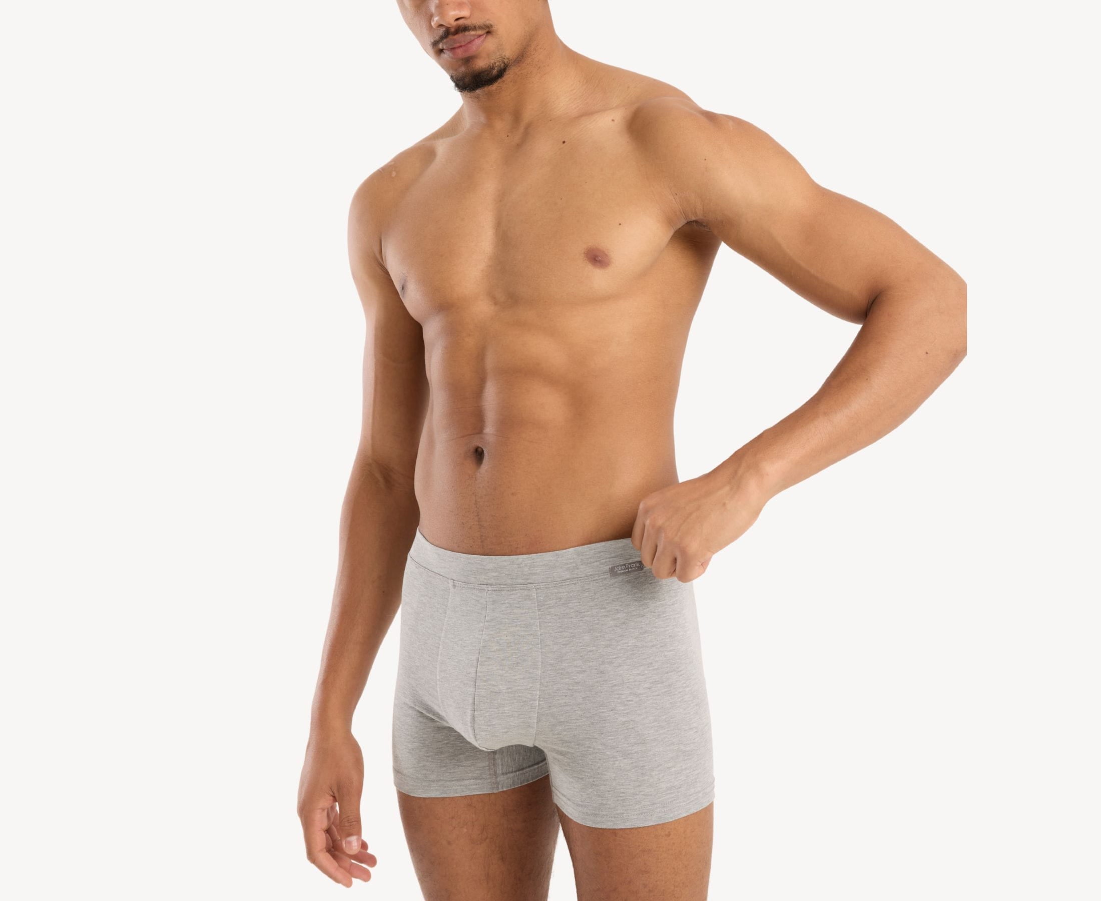 Side view of model wearing men’s 95% cotton boxer brief in stone gray with fabric-covered waistband, contoured pouch, and tailored leg cut