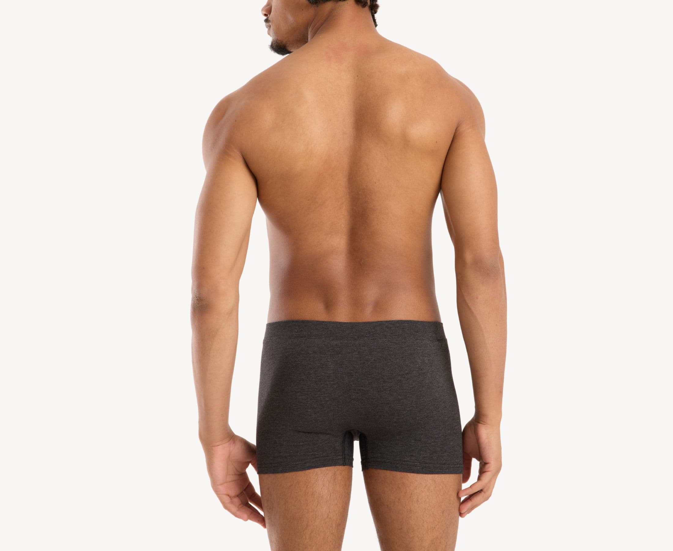 Back view of model wearing men’s 95% cotton boxer brief in slate gray with fabric-covered waistband and rear detail