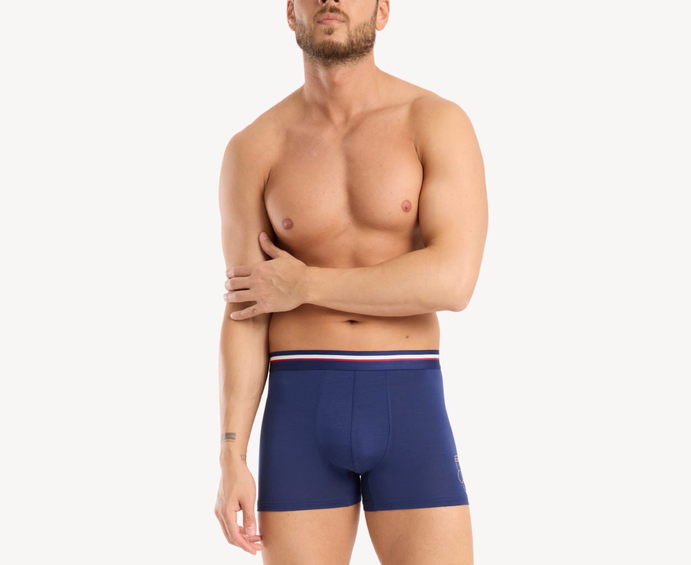 Front view of model wearing men’s 95% micromodal boxer brief in navy with coffee cup print and striped navy waistband, soft stretch and smooth finish