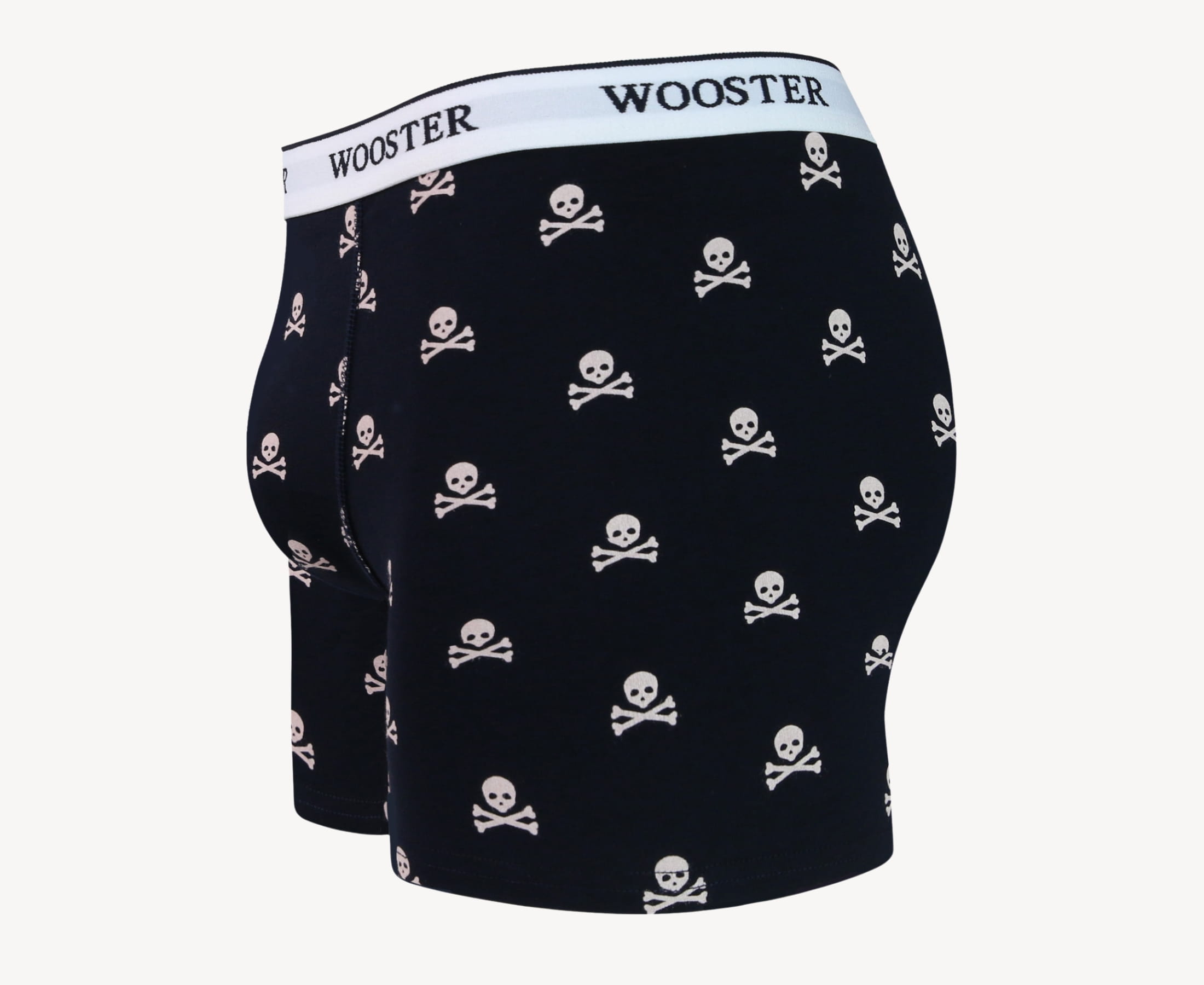 Side view of men’s 95% cotton navy boxer brief with light pink skull and bones print showing contoured pouch and relaxed fit