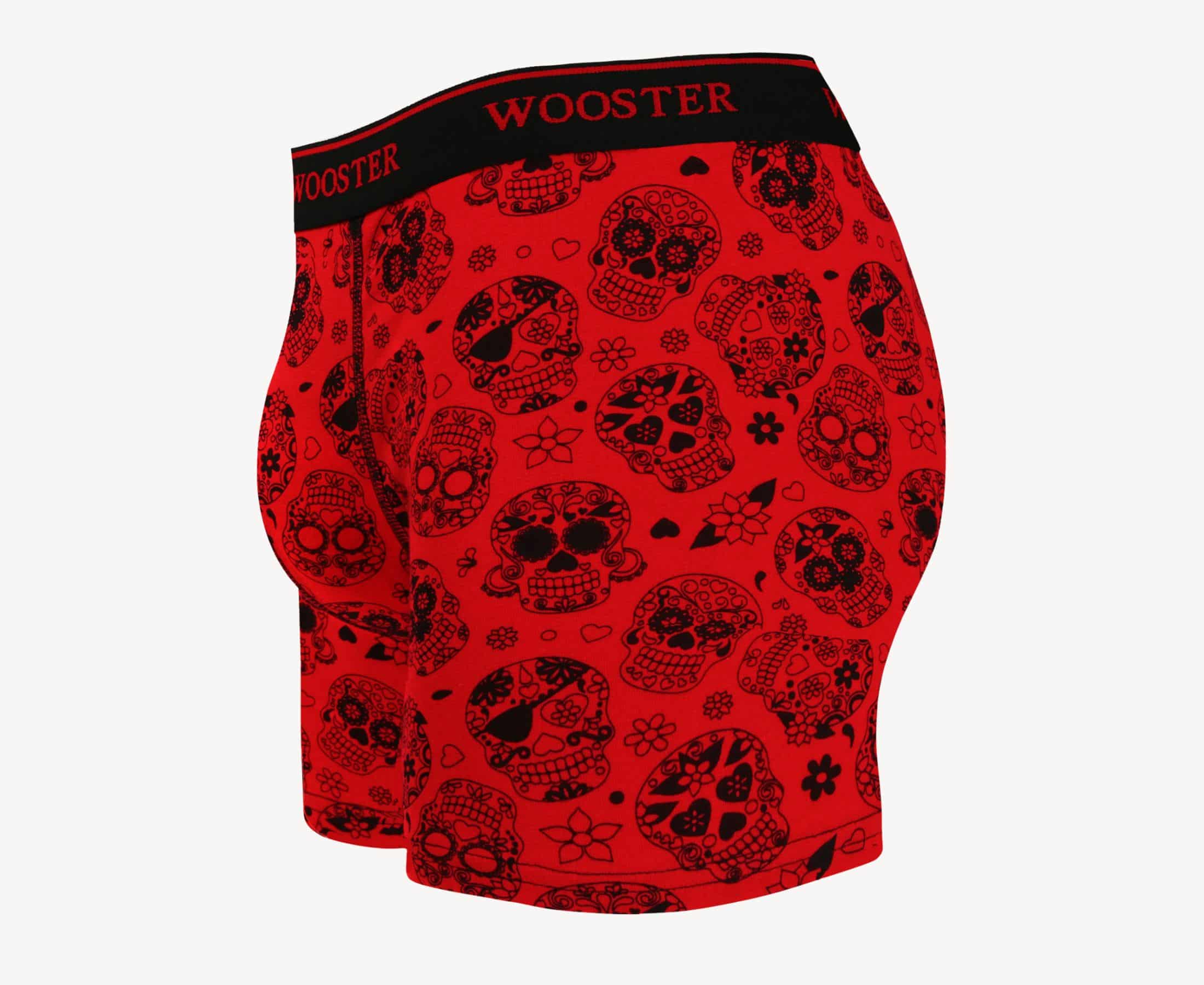 Side view of men’s 95% cotton crimson red boxer brief with black skulls in bloom print showing contoured pouch and relaxed fit