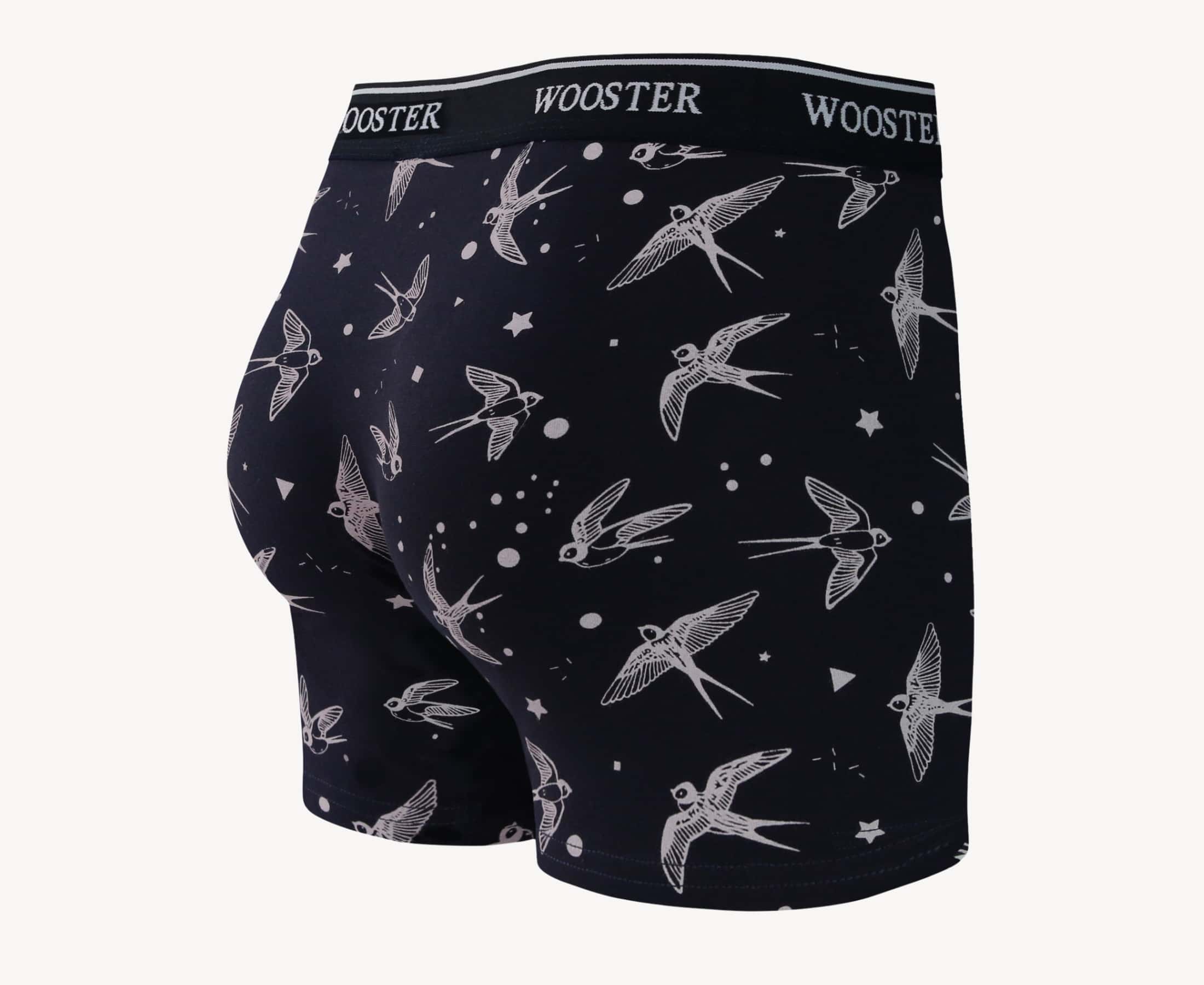 Back view of men’s 95% cotton navy boxer brief with light pink starling birds, stars, and moon print, relaxed fit, vibrant colors, and smooth rear panel