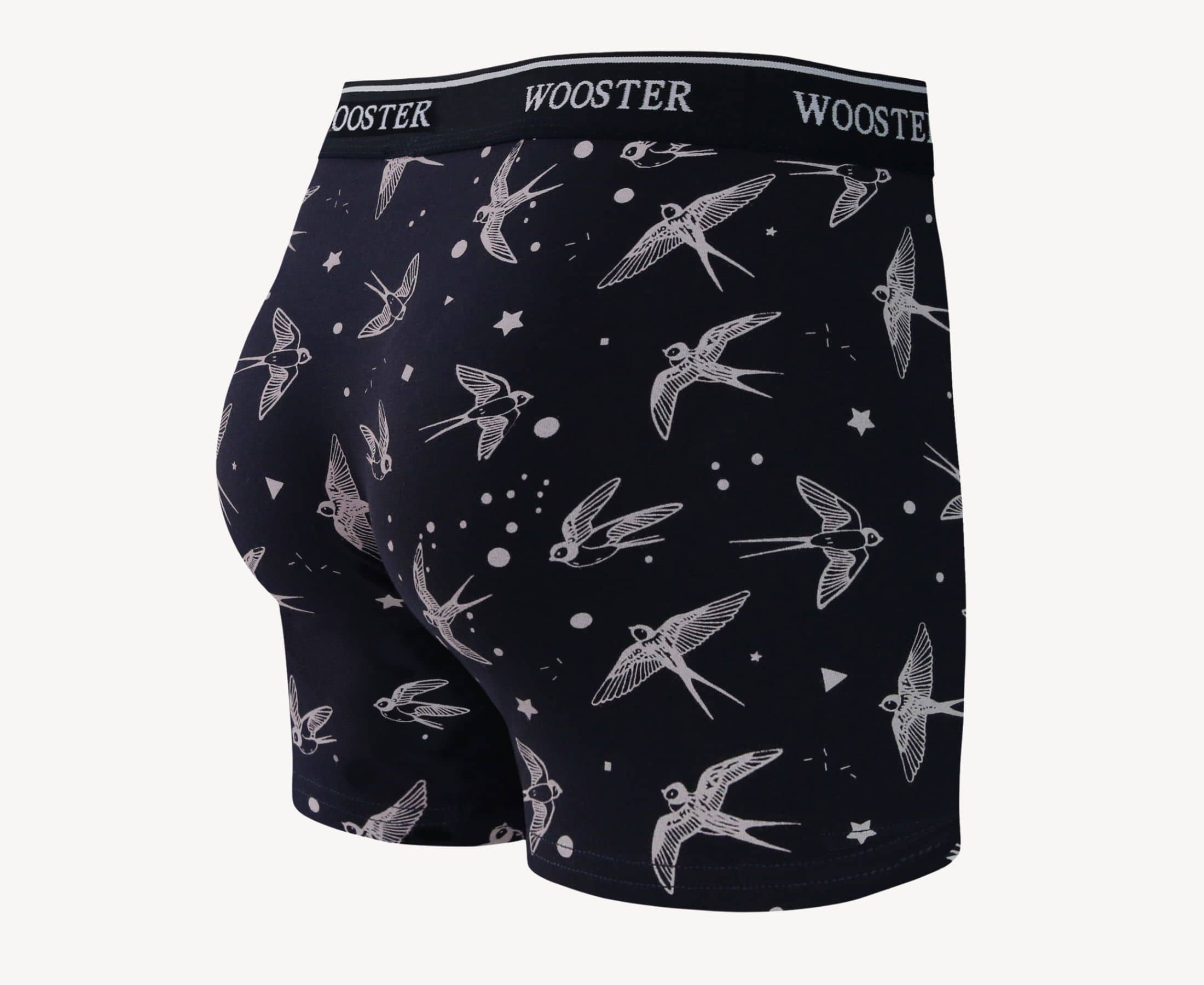 Back view of men’s 95% cotton navy boxer brief with light pink starling birds, stars, and moon print, relaxed fit, vibrant colors, and smooth rear panel