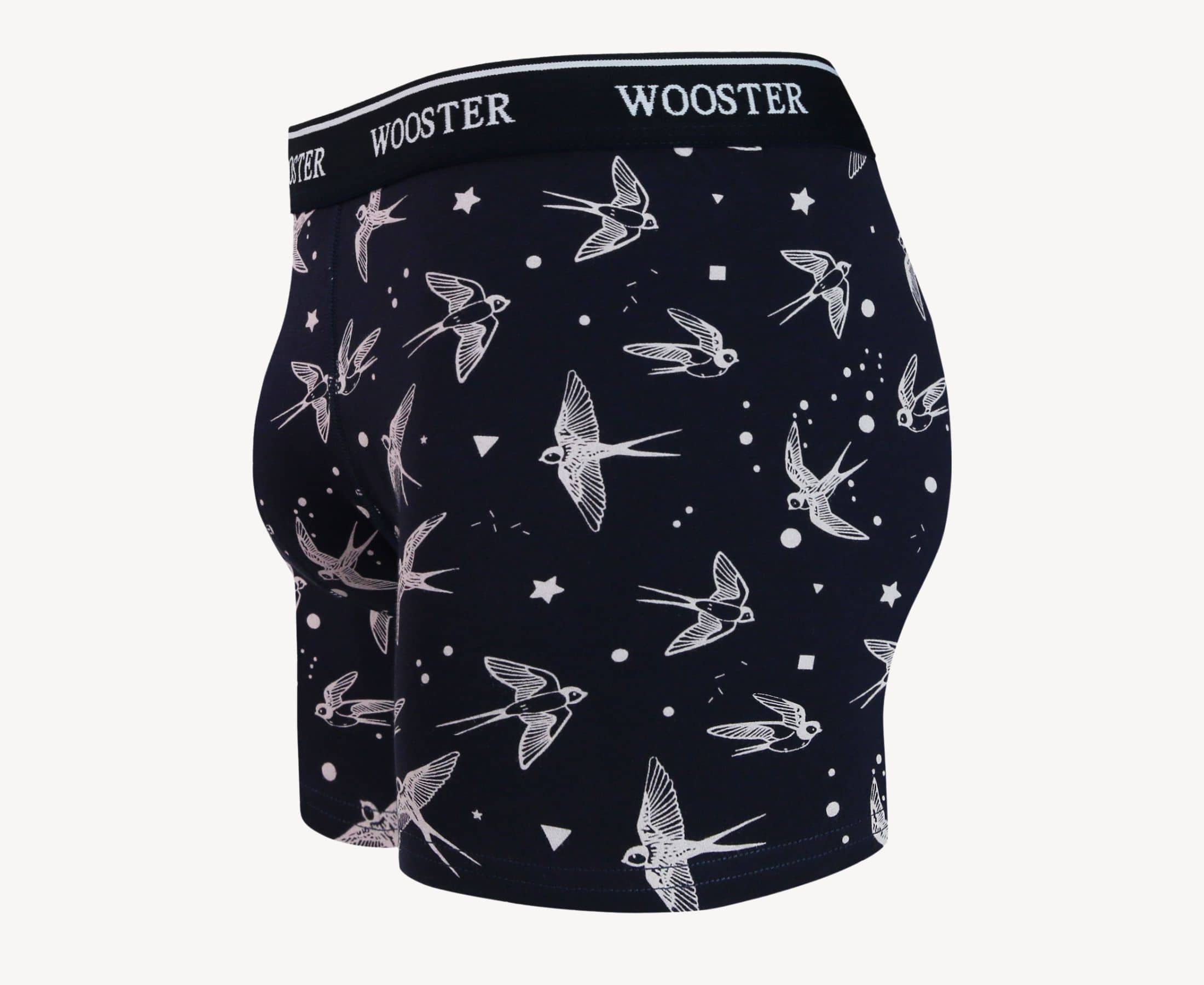 Side view of men’s 95% cotton navy boxer brief with light pink starling birds, stars, and moon print showing contoured pouch and relaxed fit