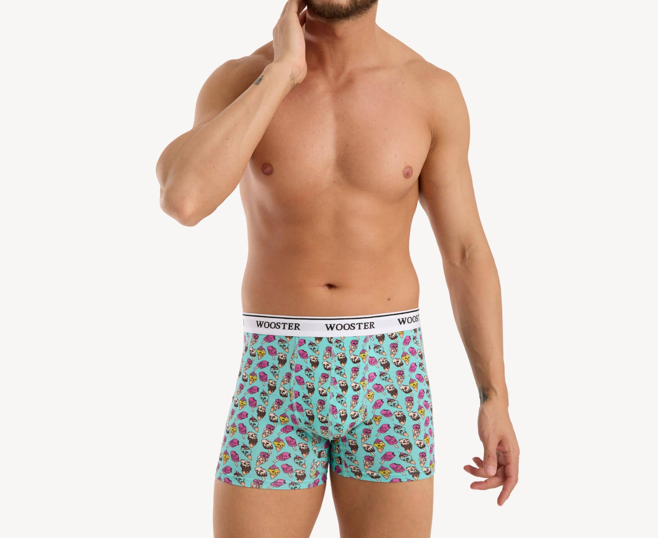 Front view of model wearing men’s 95% cotton teal boxer brief with multicolor ice cream skulls print, relaxed fit, soft stretch cotton, and no-roll waistband