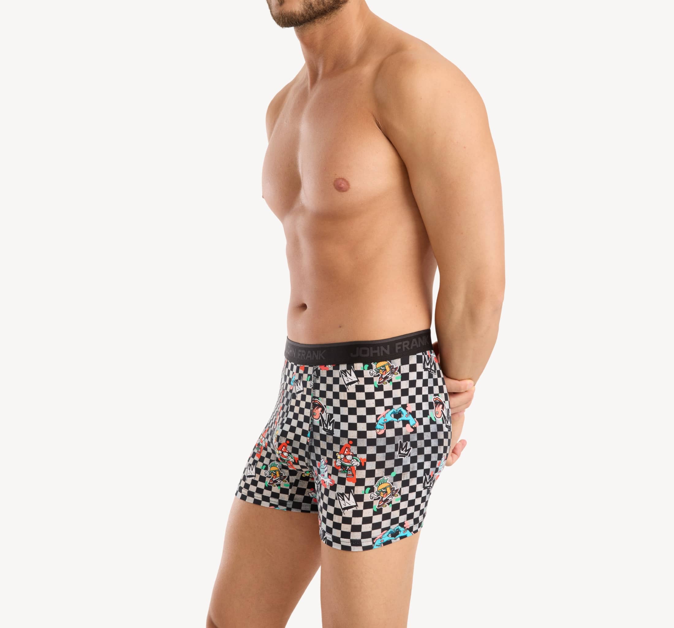 Side view of model wearing men’s 95% cotton boxer brief in checkered surrealist print with contoured pouch and tailored leg cut