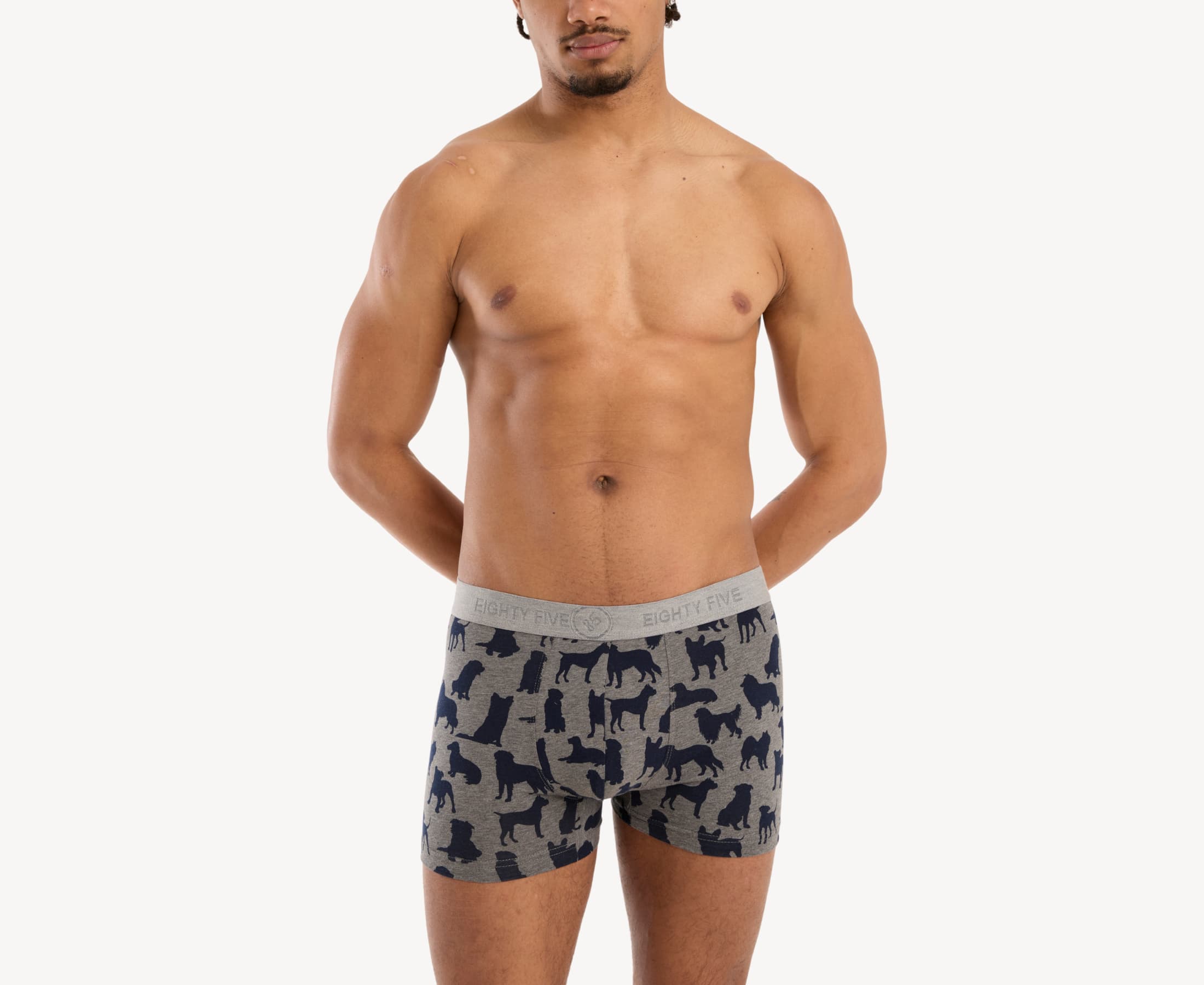 Front view of male model wearing men’s 95% cotton boxer brief in heather gray with navy dog silhouette print, featuring soft stretch waistband and contoured pouch fit