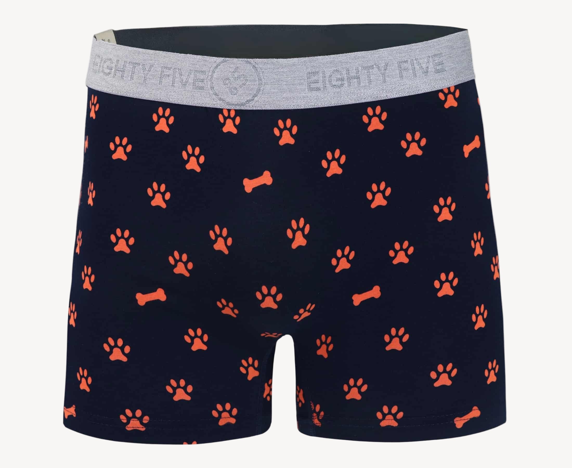 Front view of men’s 95% cotton boxer brief in navy with orange paws and bones print, soft stretch, and no-roll waistband