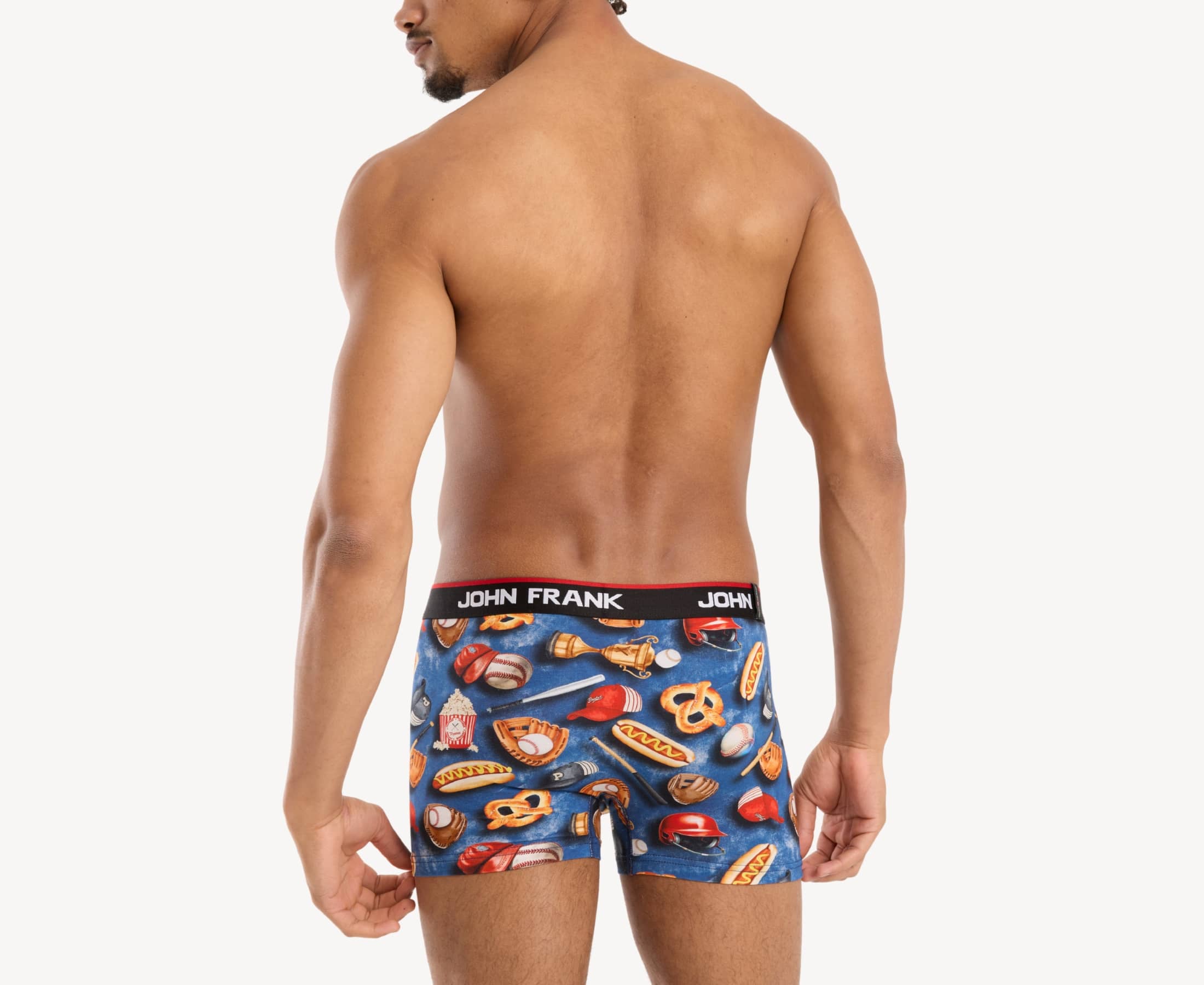 Back view of model wearing men’s 95% cotton boxer brief in multicolor baseball-inspired print with smooth waistband and rear detail