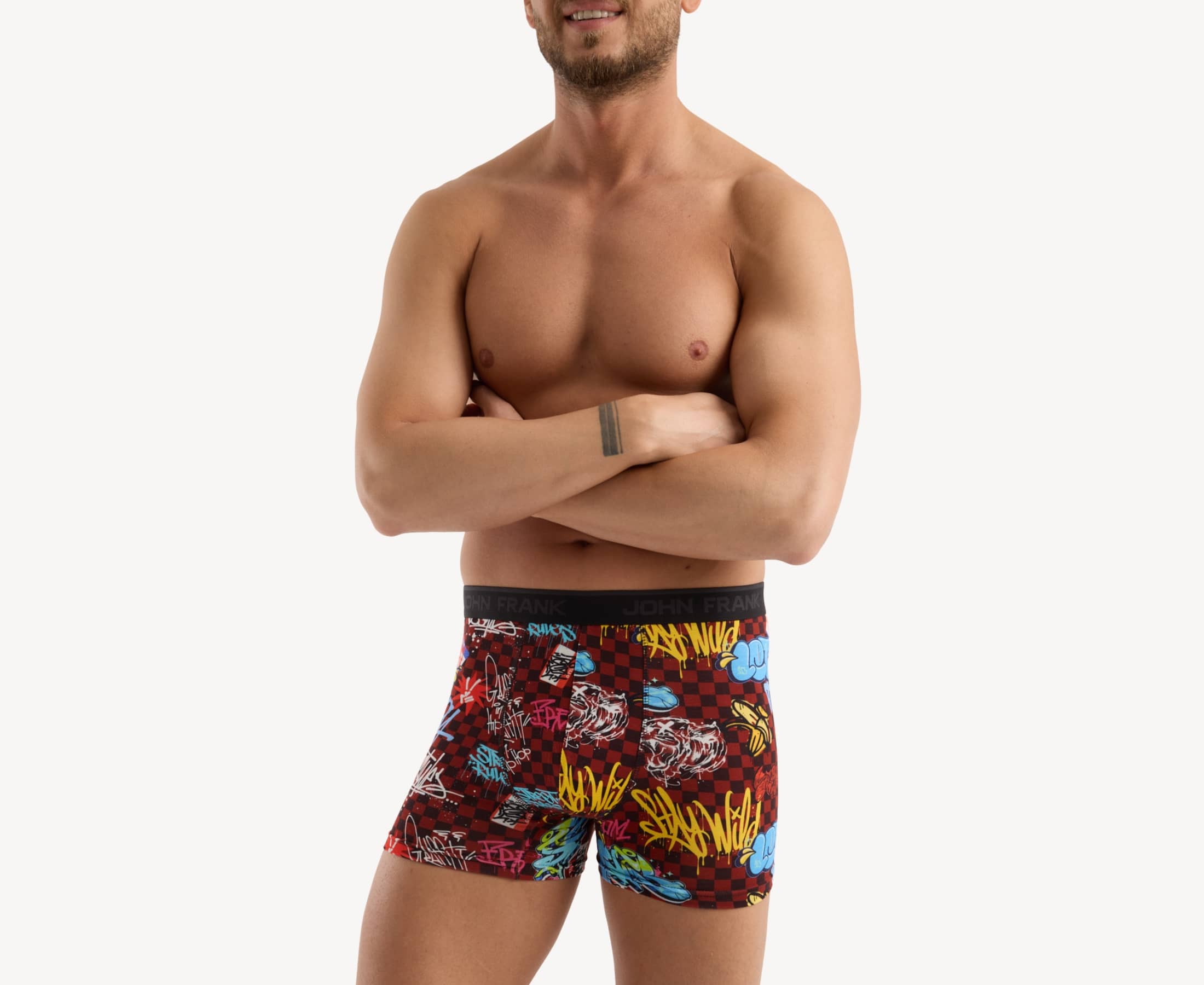 Front view of model wearing men’s 95% micromodal boxer brief in burgundy with graffiti-inspired print, soft stretch and no-roll waistband