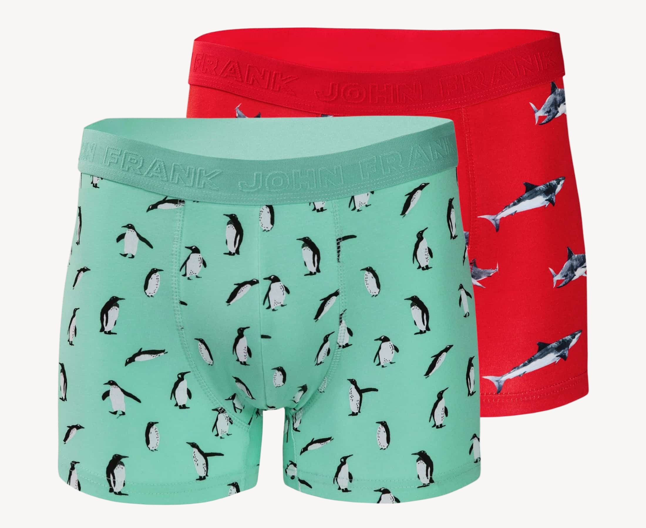 Full pack view of men’s 95% cotton boxer brief 2-pack — one turquoise with penguins, one coral with sharks