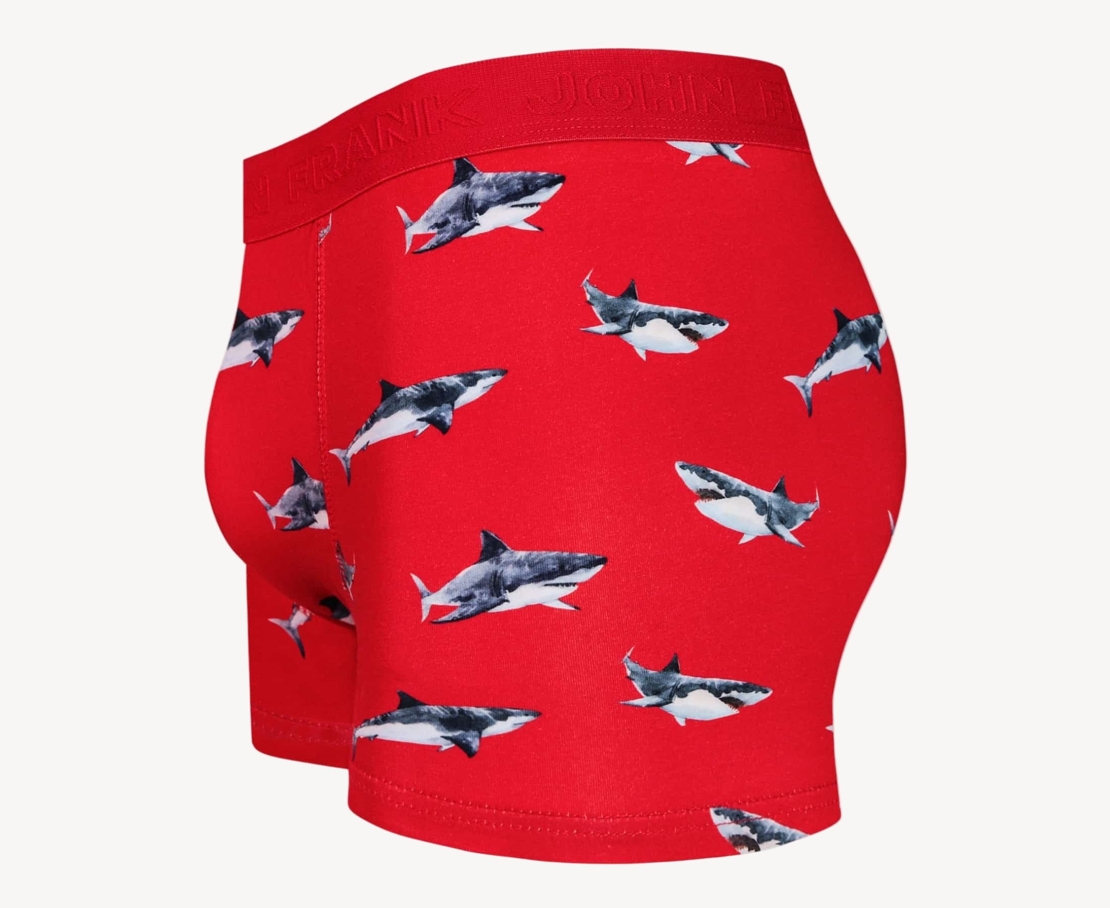 Side view of men’s 95% cotton boxer brief in coral with shark print, contoured pouch, and tailored leg cut