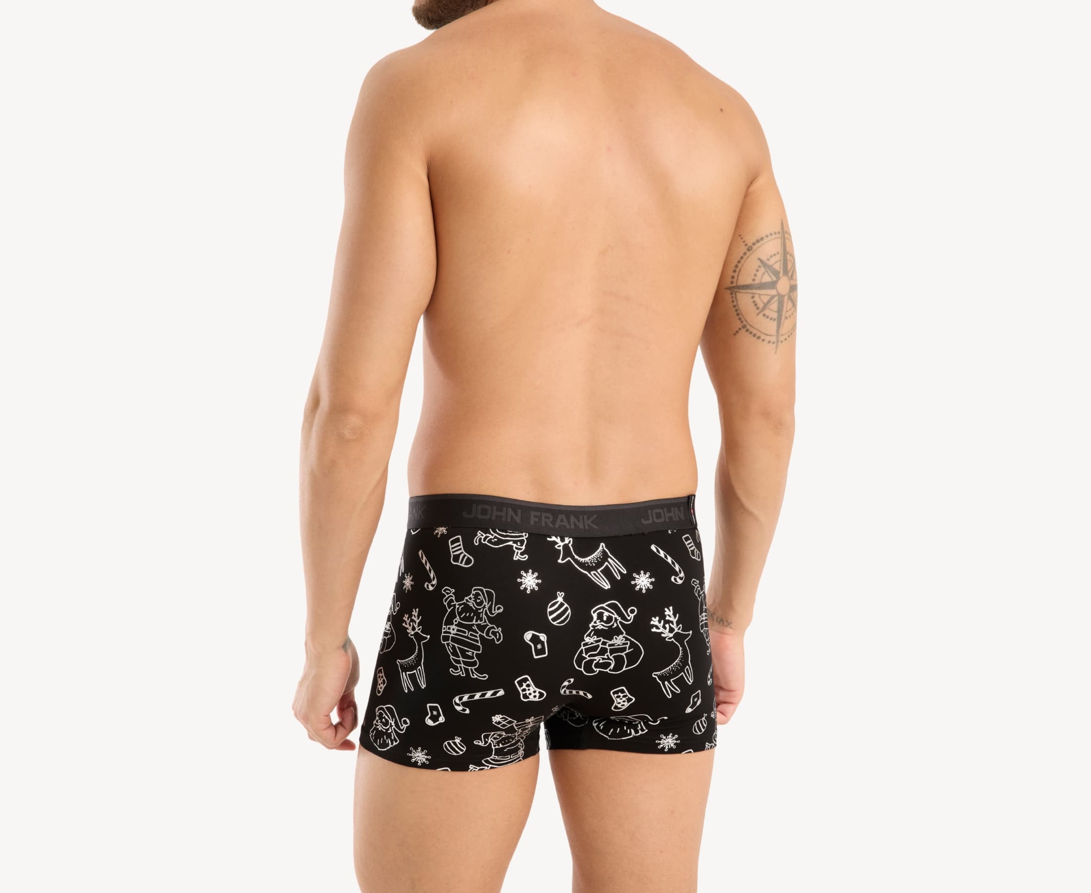 Back view of male model wearing men’s 95% cotton boxer brief in black with shiny silver Christmas doodles print, showing waistband detail