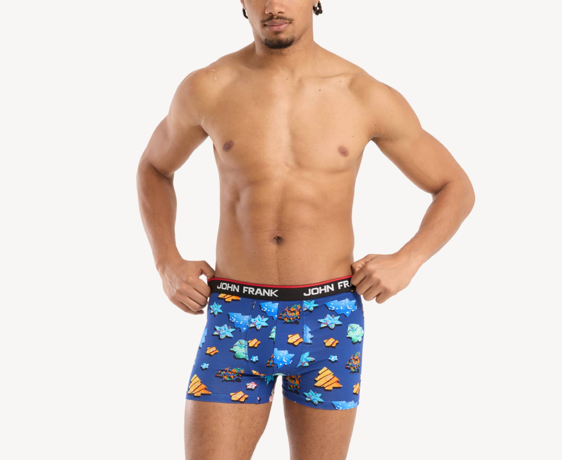Front view of male model wearing men’s 95% cotton boxer brief in royal blue with colorful sugar cookies print, showing smooth waistband and contoured fit