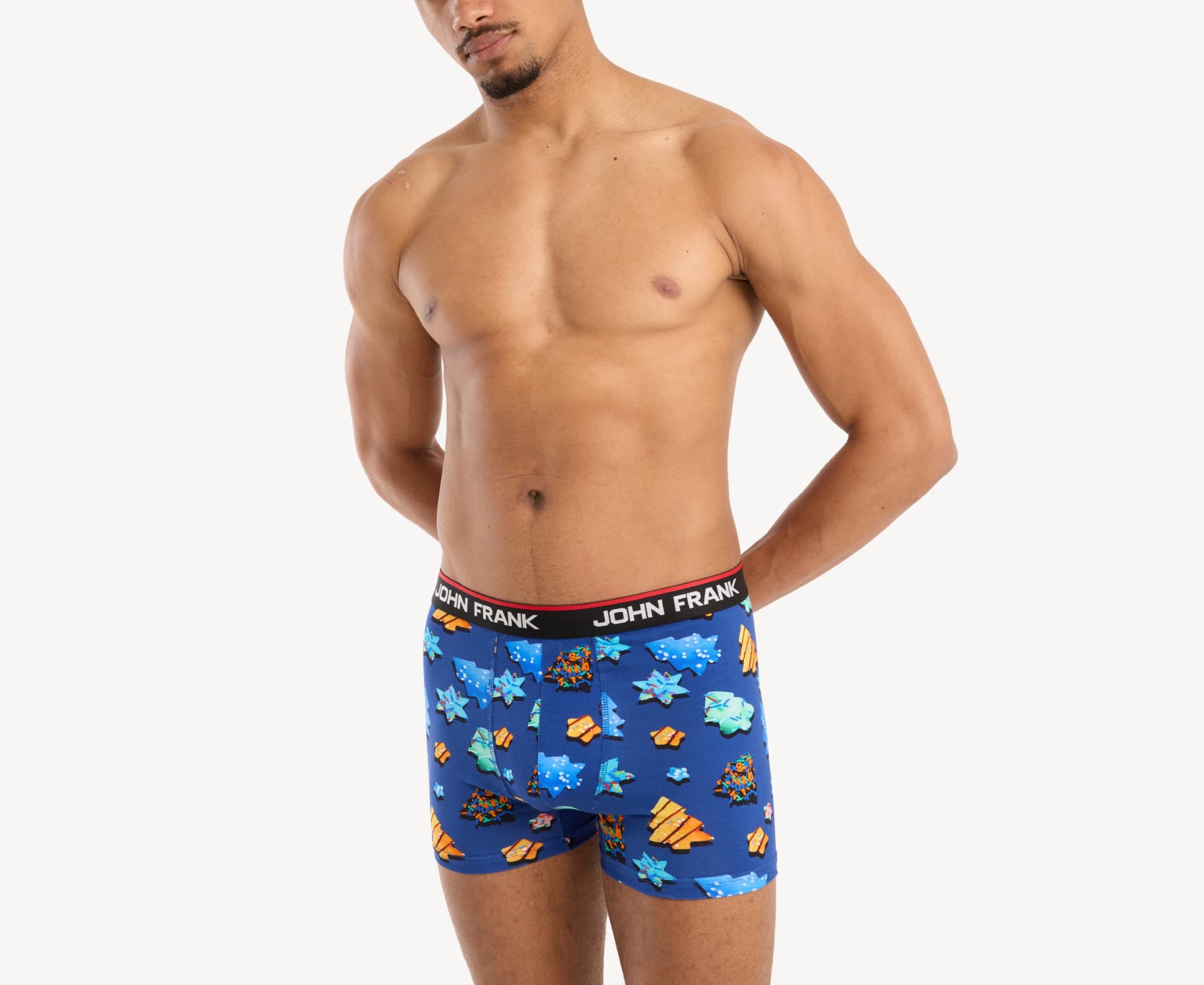 Front side view of male model wearing men’s 95% cotton boxer brief in royal blue with colorful sugar cookies print, showing smooth waistband and contoured fit