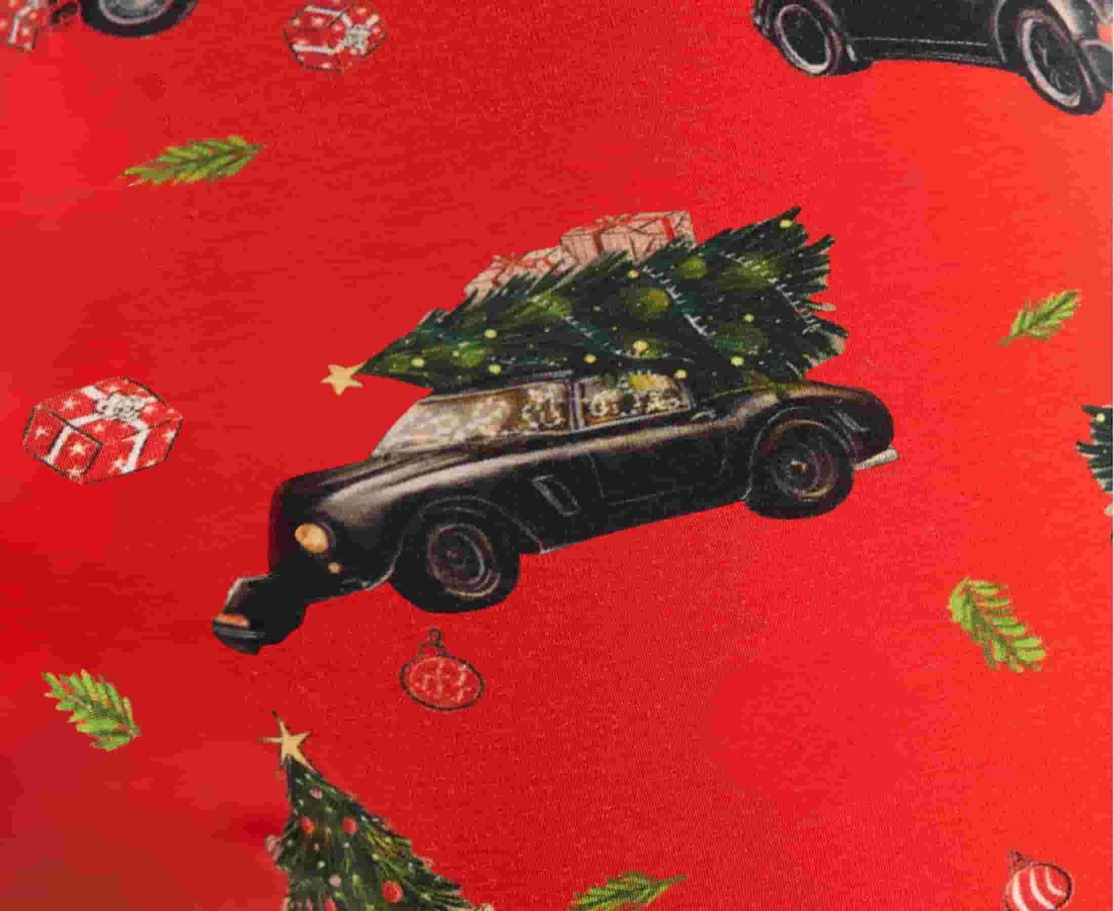 Fabric detail showing a black car with Christmas tree tied up top on a red background