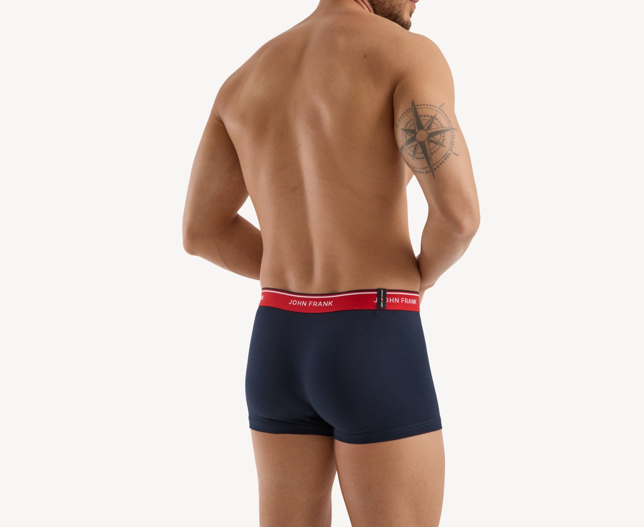 Back view of model wearing men’s 95% cotton boxer brief in midnight blue with cherry red striped waistband and rear detail