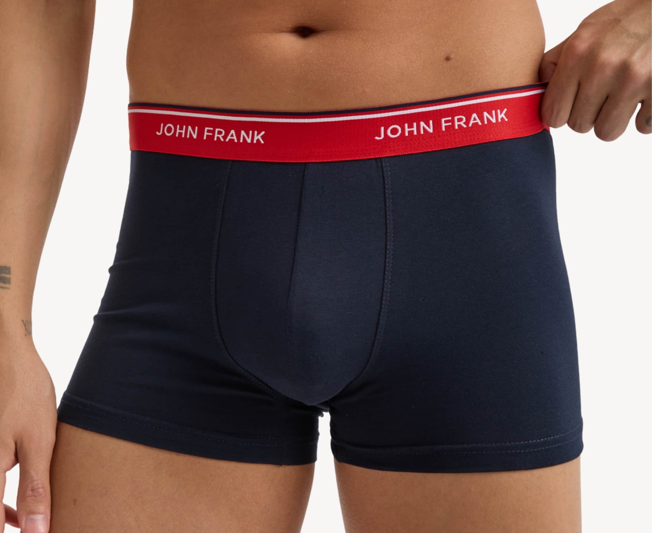 Front view of model wearing men’s 95% cotton boxer brief in midnight blue with cherry red striped waistband and soft stretch