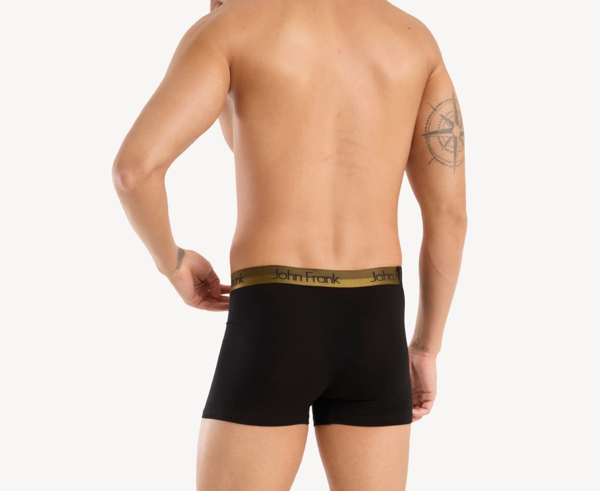 Back view of model wearing men’s 95% cotton boxer brief in black with yellow-metal shiny waistband and rear detail