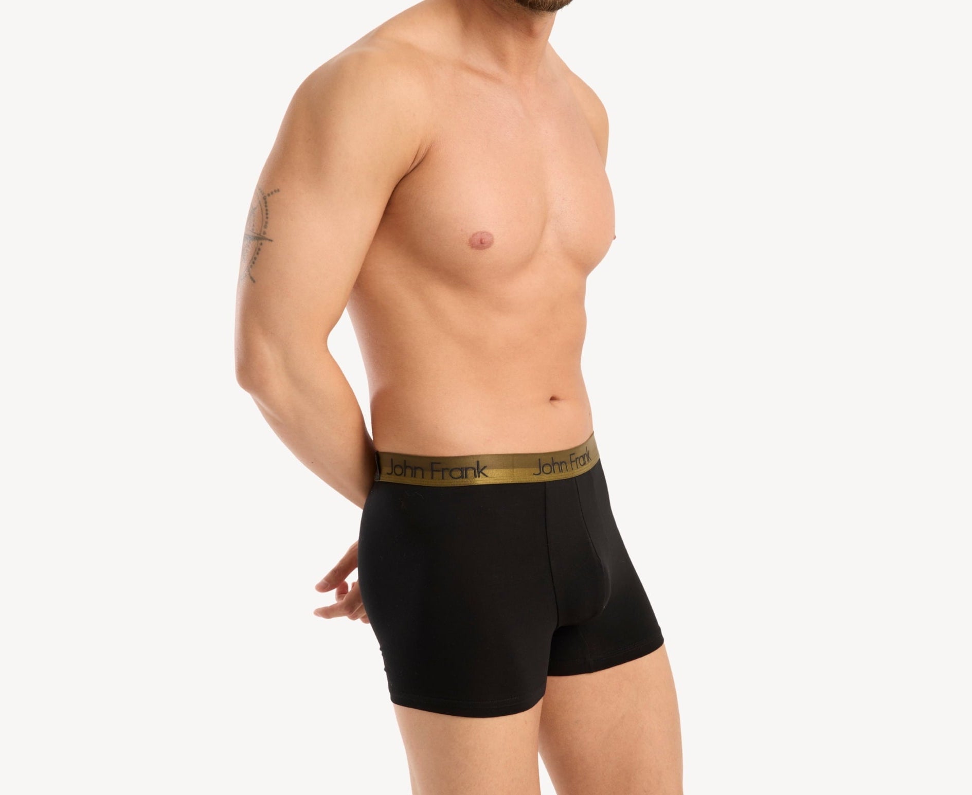 Side view of model wearing men’s 95% cotton boxer brief in black with yellow-metal shiny waistband, contoured pouch, and tailored leg cut