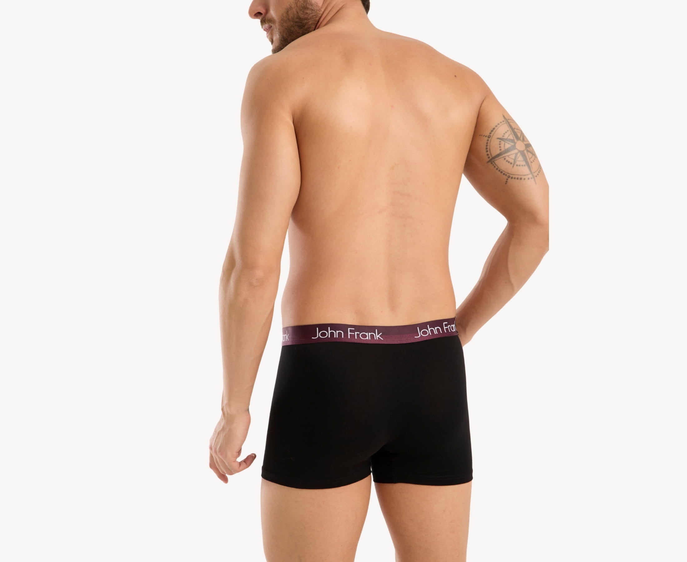 Back view of model wearing men’s 95% cotton boxer brief in black with burgundy shiny waistband and rear detail