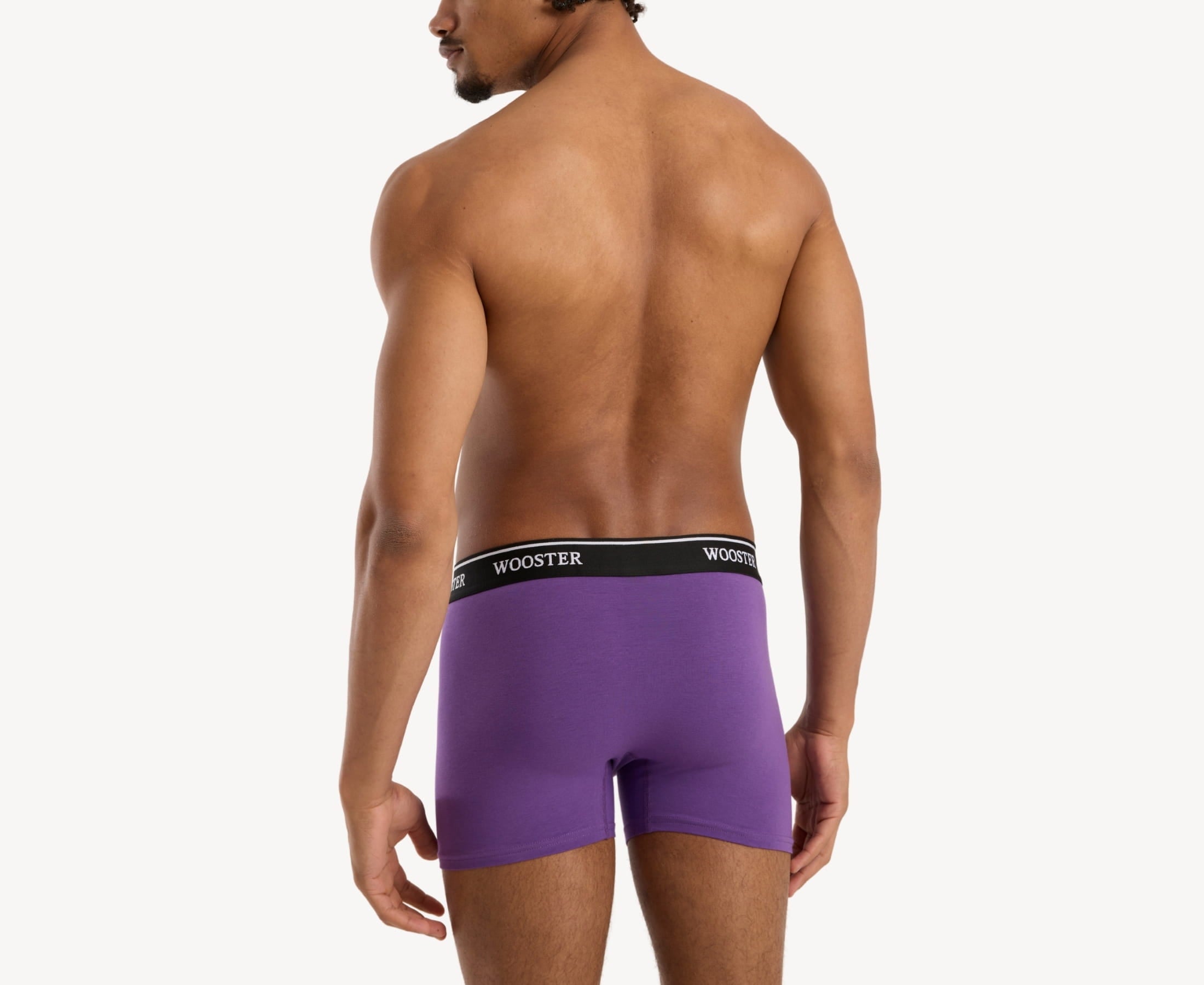Back view of model wearing men’s 95% cotton boxer brief in mulberry with relaxed fit, vibrant color, and smooth rear panel