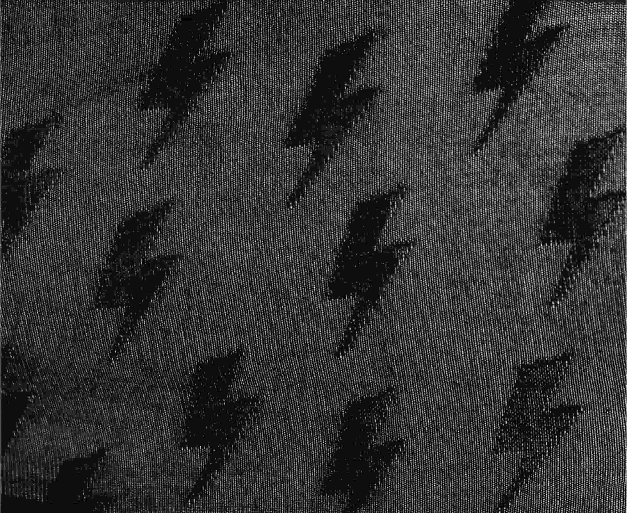 Detailed view of black fabric with jacquard lightening flash pattern