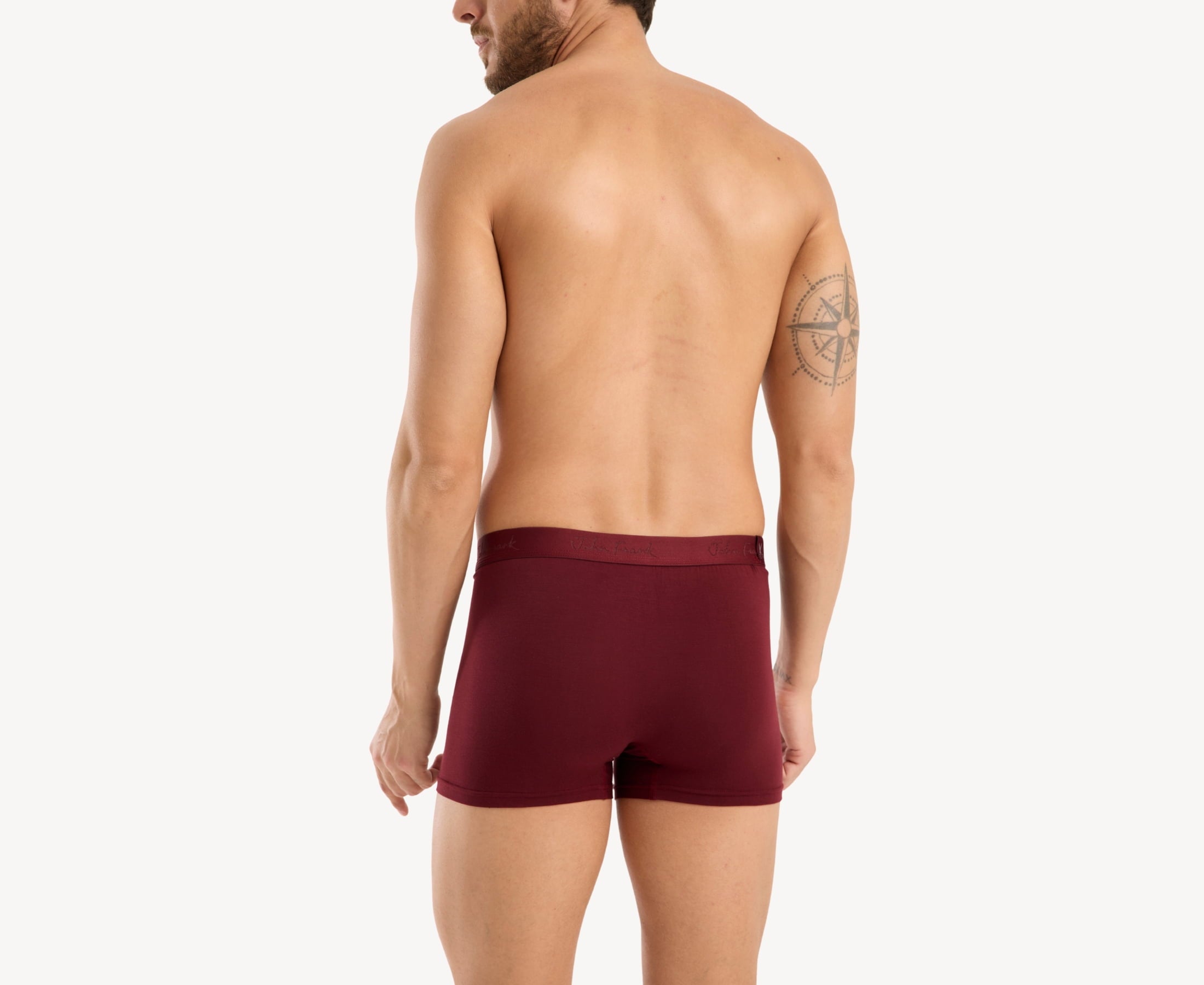 Back view of model wearing men’s 95% micromodal boxer brief in bordeaux with tonal waistband featuring subtle sheen and clean rear detail