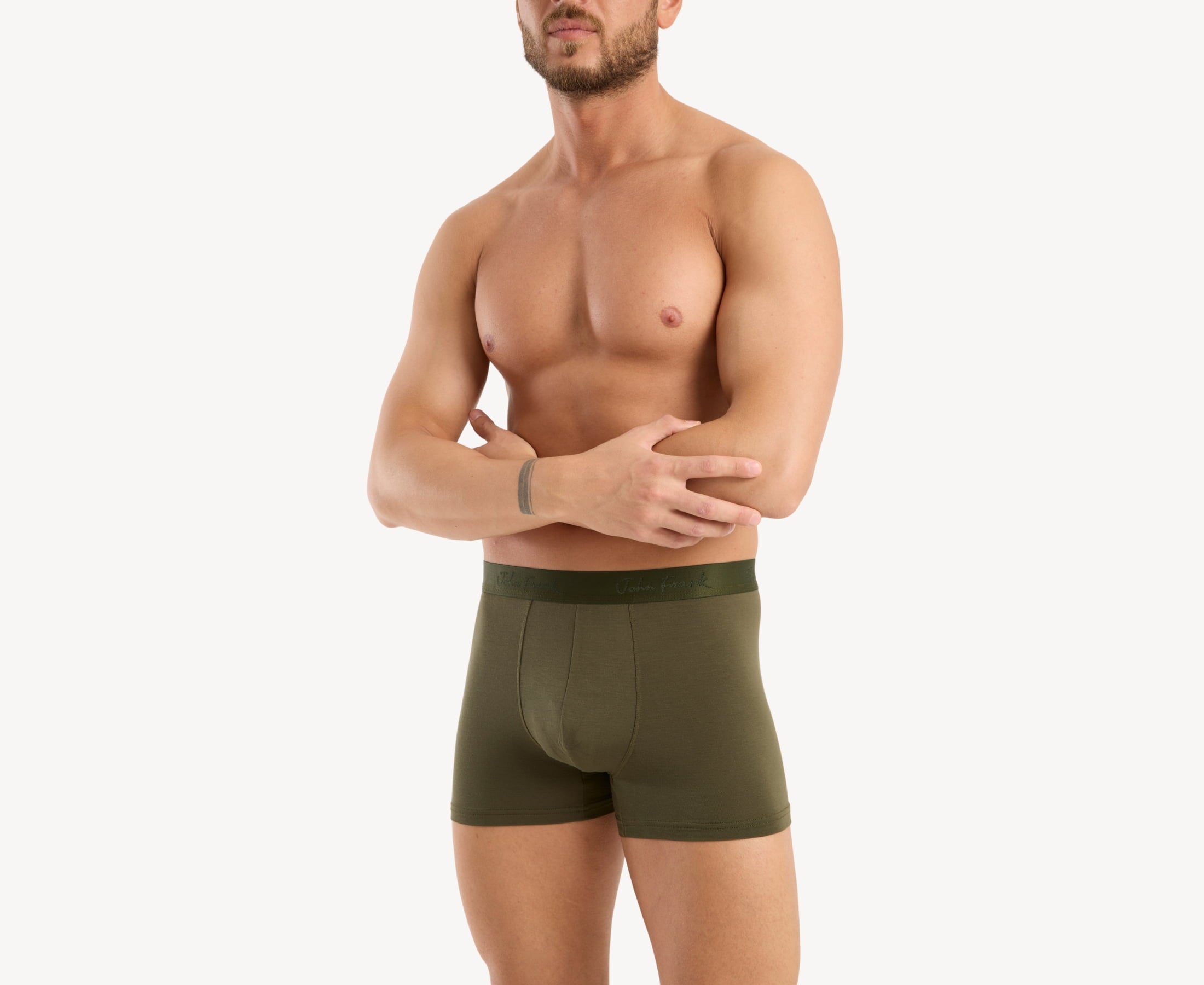 Front side view of model wearing men’s 95% micromodal boxer brief in olive with tonal waistband featuring subtle sheen, and soft stretch