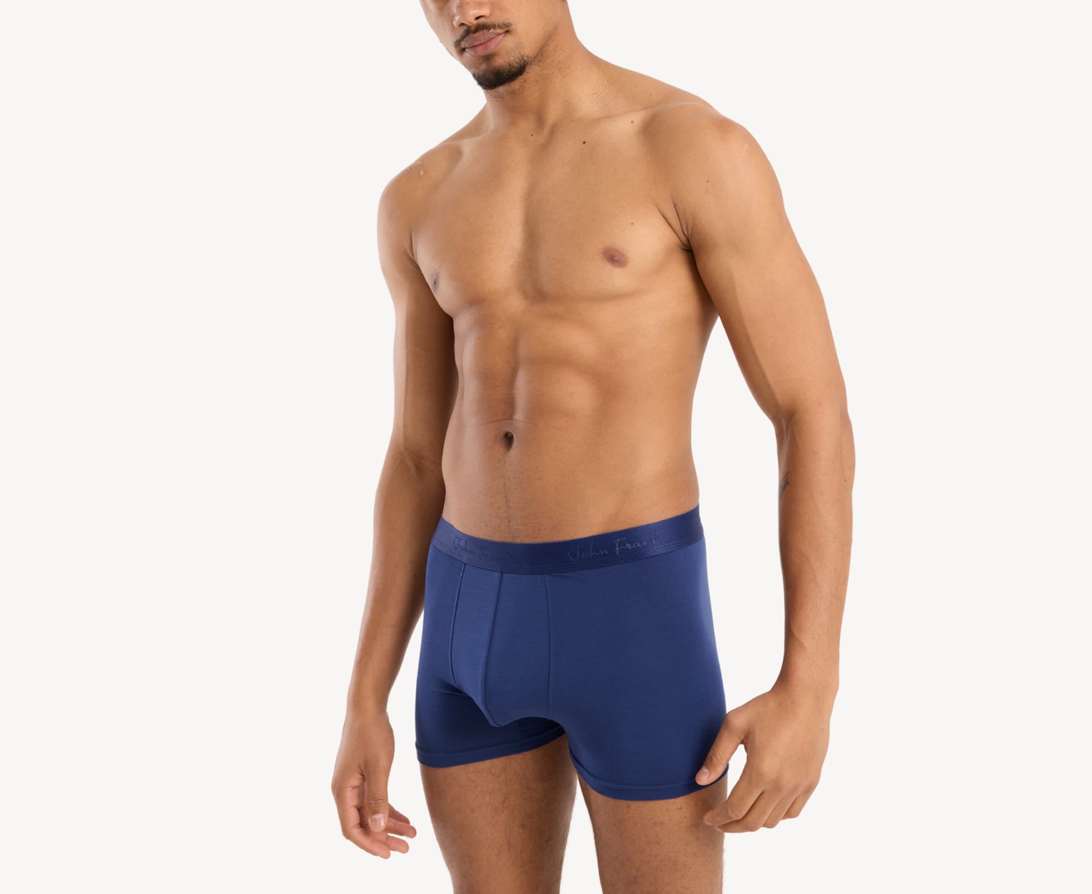 Side view of model wearing men’s 95% micromodal boxer brief in royal blue with contoured pouch and tailored leg cut