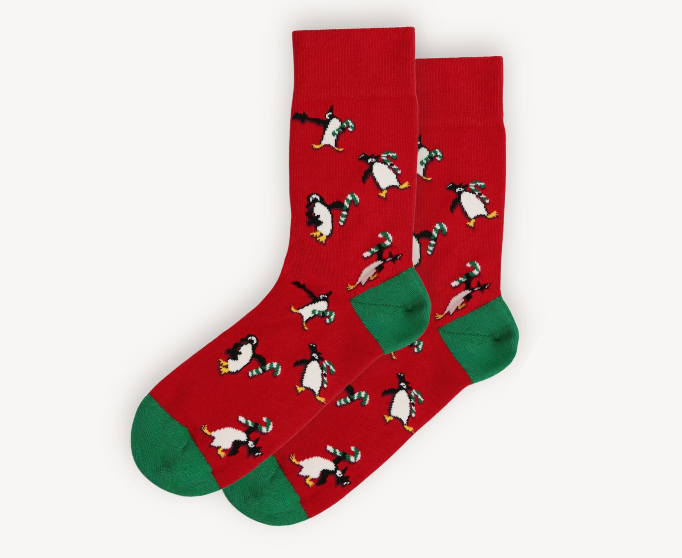 Front view of men’s 80% cotton crew socks in red with playful penguin and candy cane knit, green heels and toes