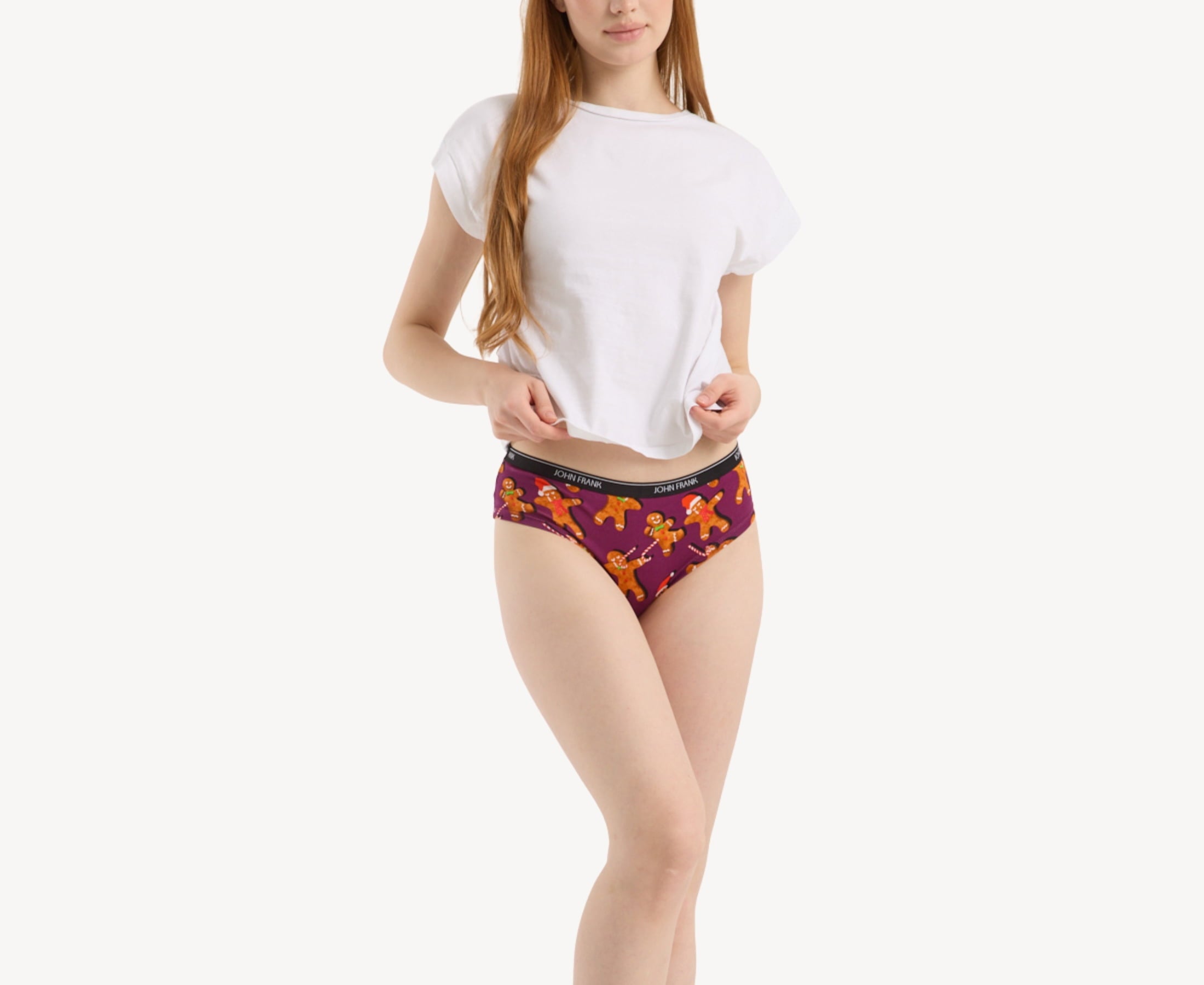 Front view of model wearing women's 95% premium cotton hipster in purple with festive ginger bread cookies print, showcasing mid-rise cut and smooth waistband.