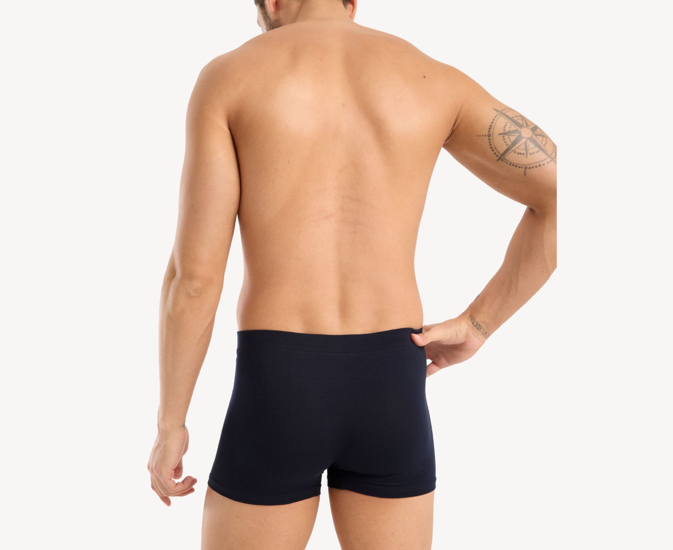 Back view of model wearing men’s 95% cotton boxer brief in navy with fabric-covered waistband and rear detail