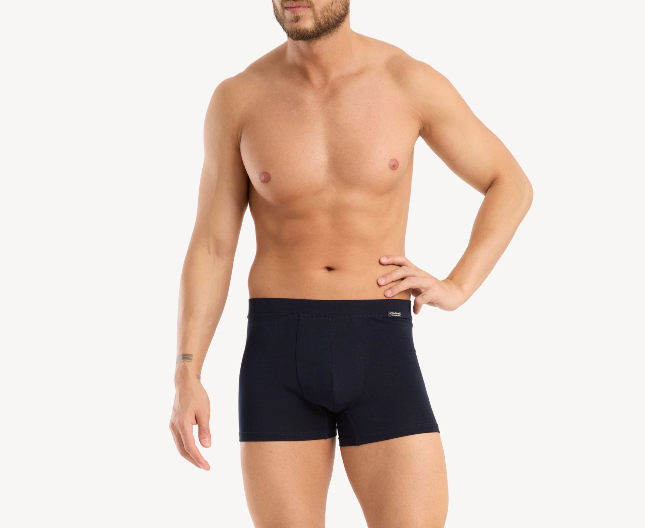 Front view of model wearing men’s 95% cotton boxer brief in navy with fabric-covered waistband, invisible seams and soft stretch
