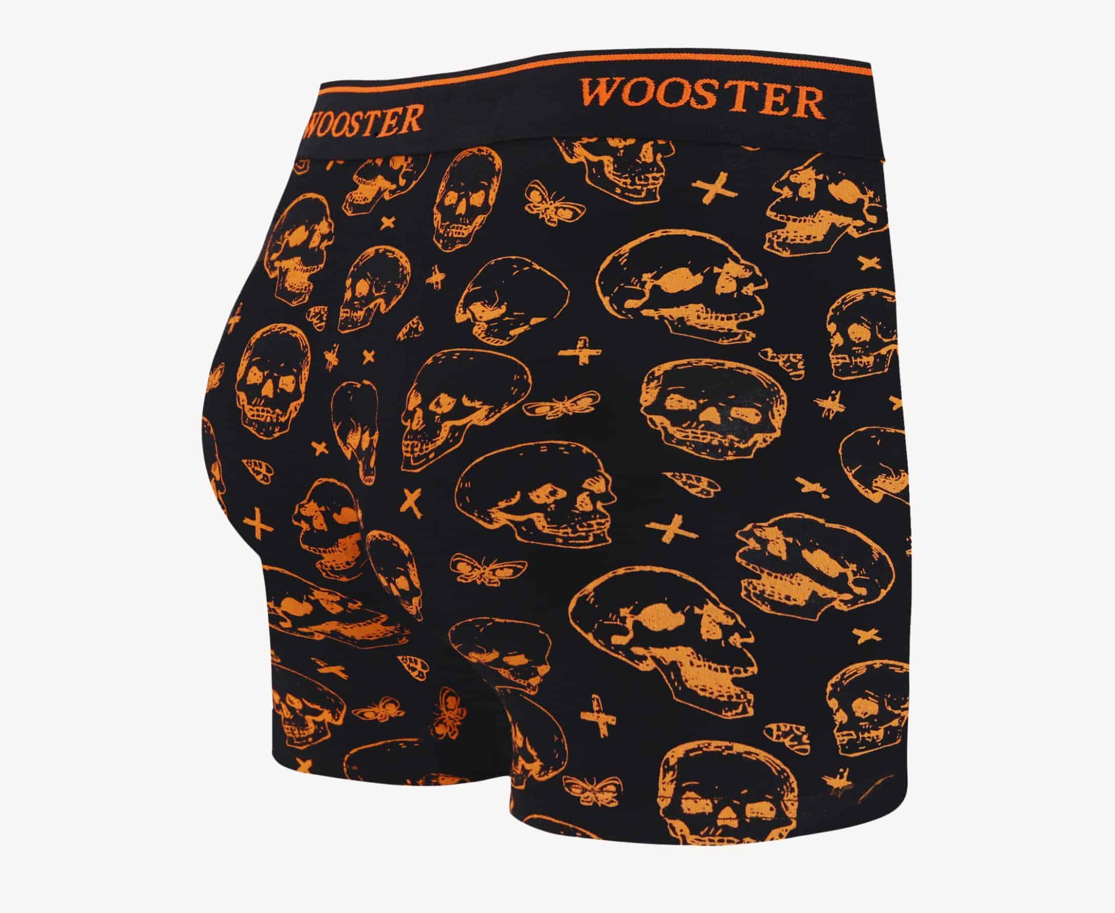 Back view of men’s 95% cotton black boxer brief with orange skulls print, relaxed fit, vibrant colors, and smooth rear panel
