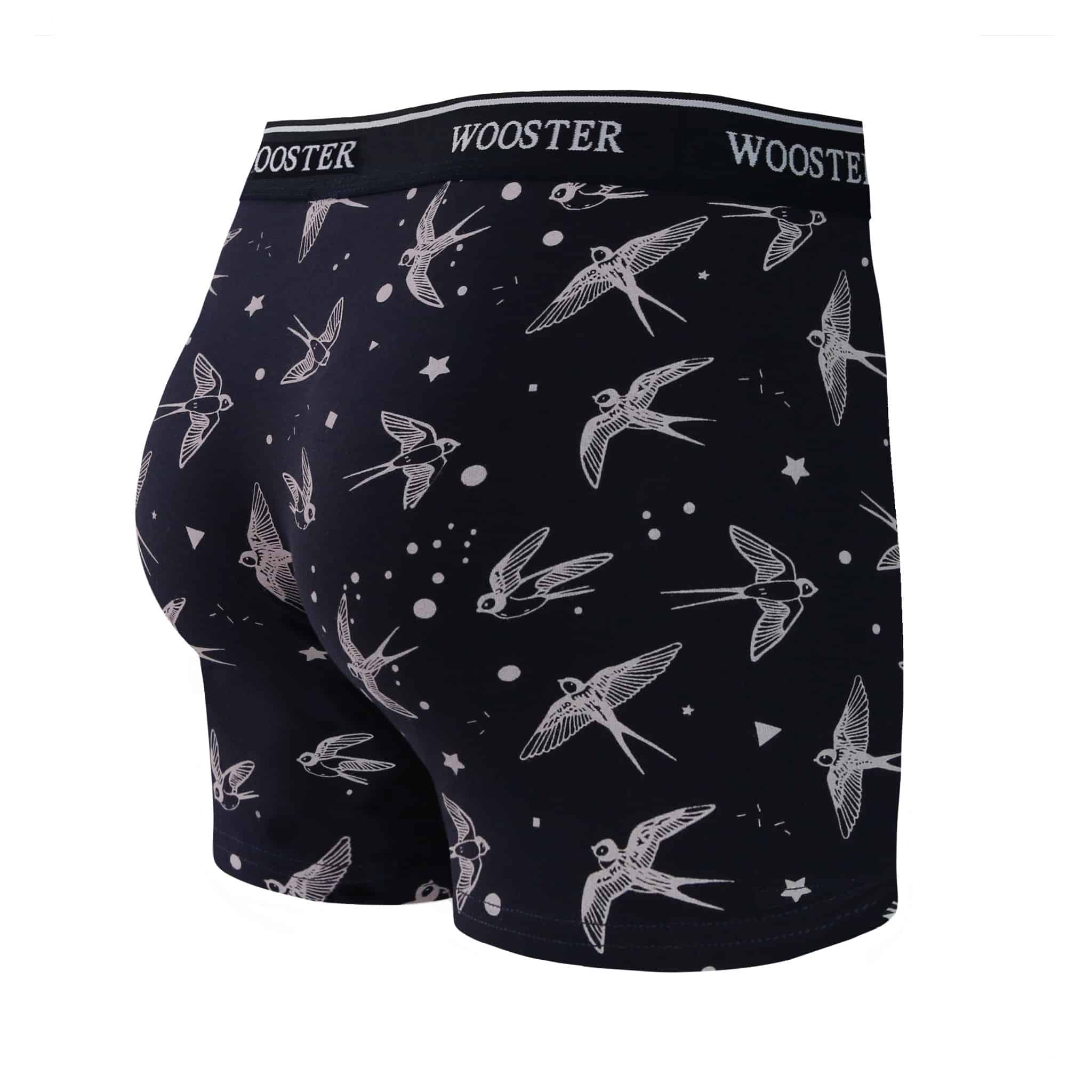 Back view of men’s 95% cotton navy boxer brief with light pink starling birds, stars, and moon print, relaxed fit, vibrant colors, and smooth rear panel