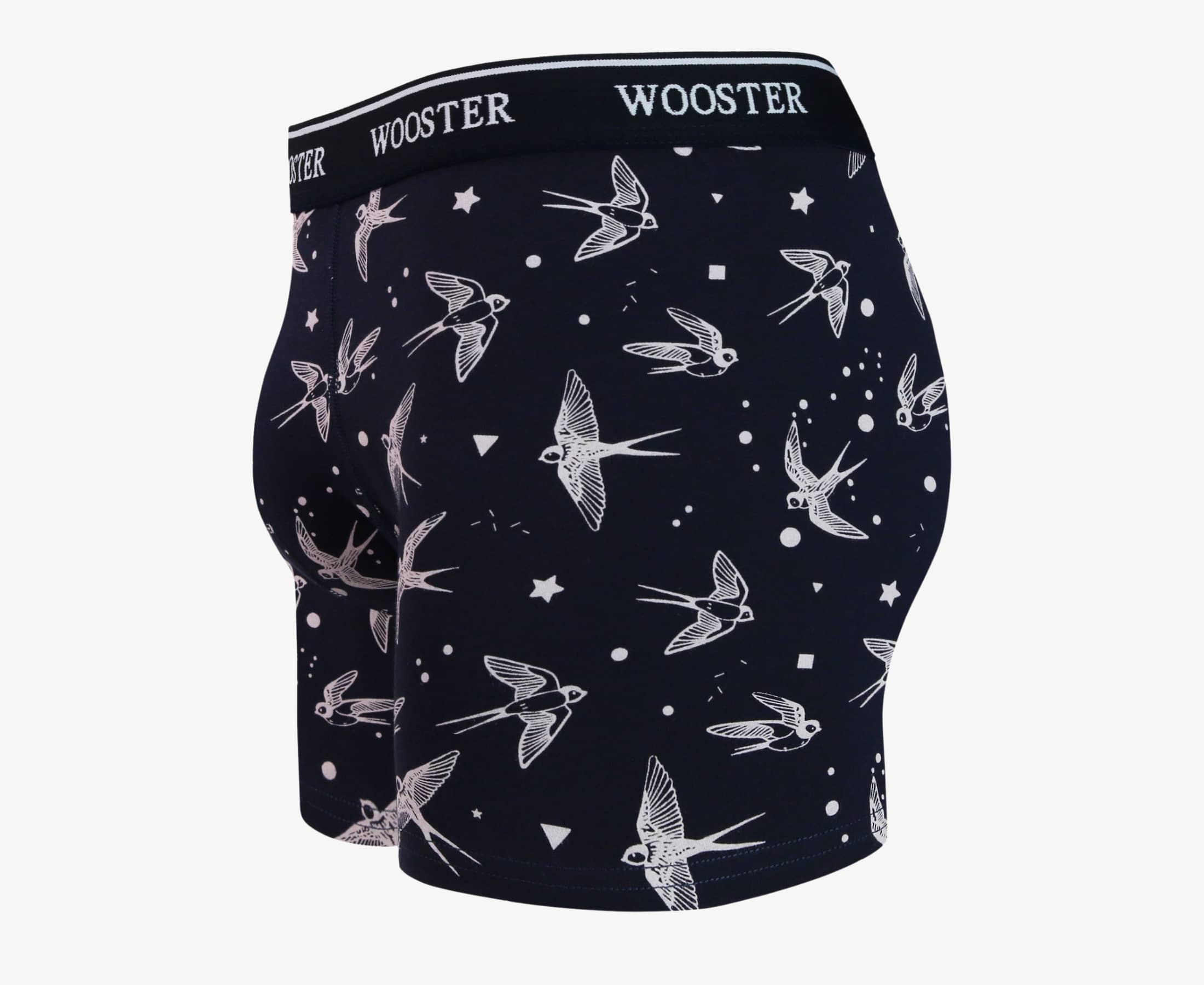 Side view of men’s 95% cotton navy boxer brief with light pink starling birds, stars, and moon print showing contoured pouch and relaxed fit