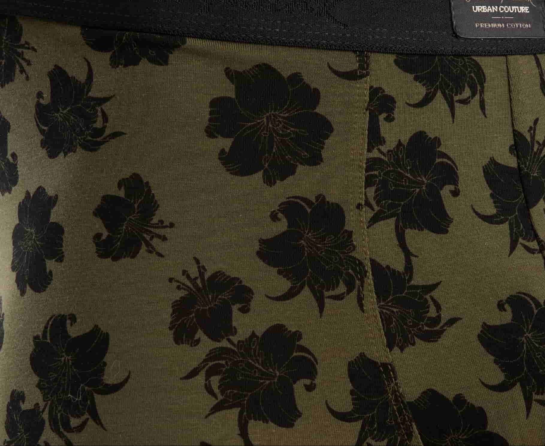 Olive colored fabric detail with black hibiscus flower patterns and urban couture and premium cotton branding on waistband