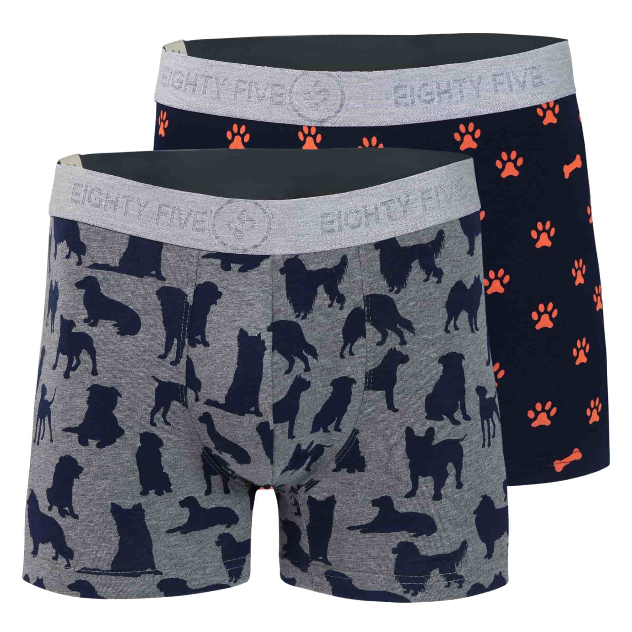 Full pack view of men’s 95% cotton boxer brief 2-pack — one navy with orange paws and bones, one gray with navy dog print