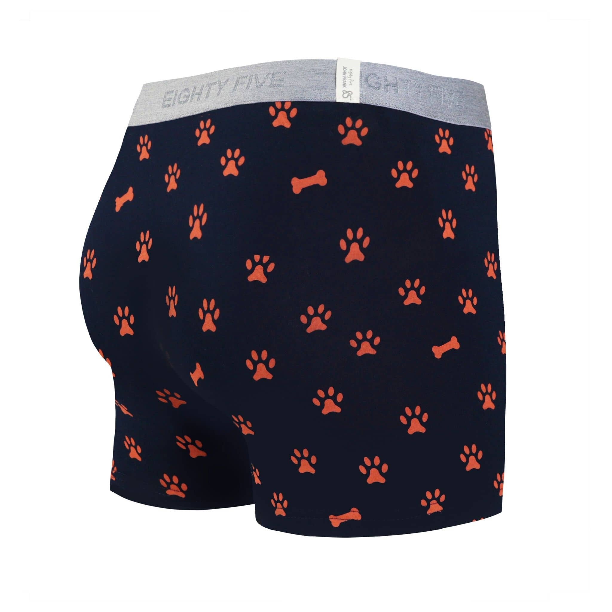 Back view of men’s 95% cotton boxer brief in navy with orange paws and bones print, smooth waistband, and rear detail