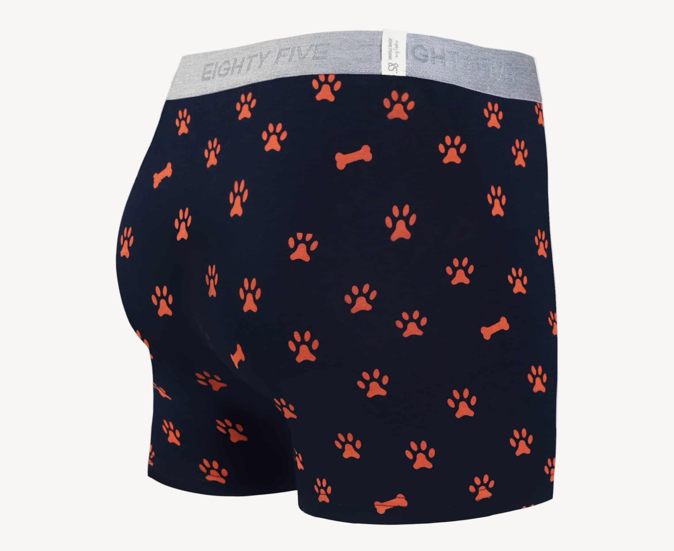 Back view of men’s 95% cotton boxer brief in navy with orange paws and bones print, smooth waistband, and rear detail