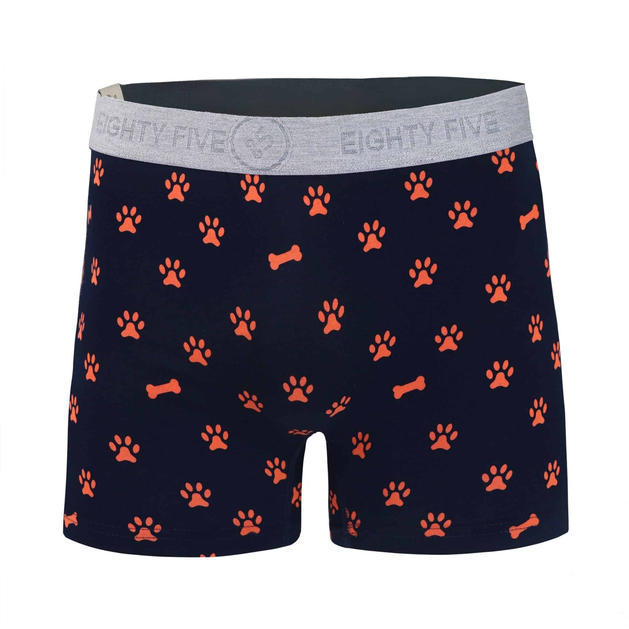 Front view of men’s 95% cotton boxer brief in navy with orange paws and bones print, soft stretch, and no-roll waistband