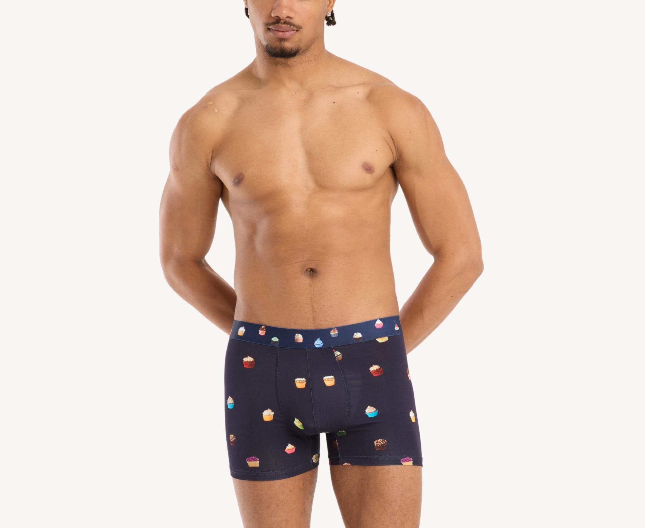 Front view of model wearing men’s 95% micromodal boxer brief in navy with cupcake print, soft stretch and no-roll waistband