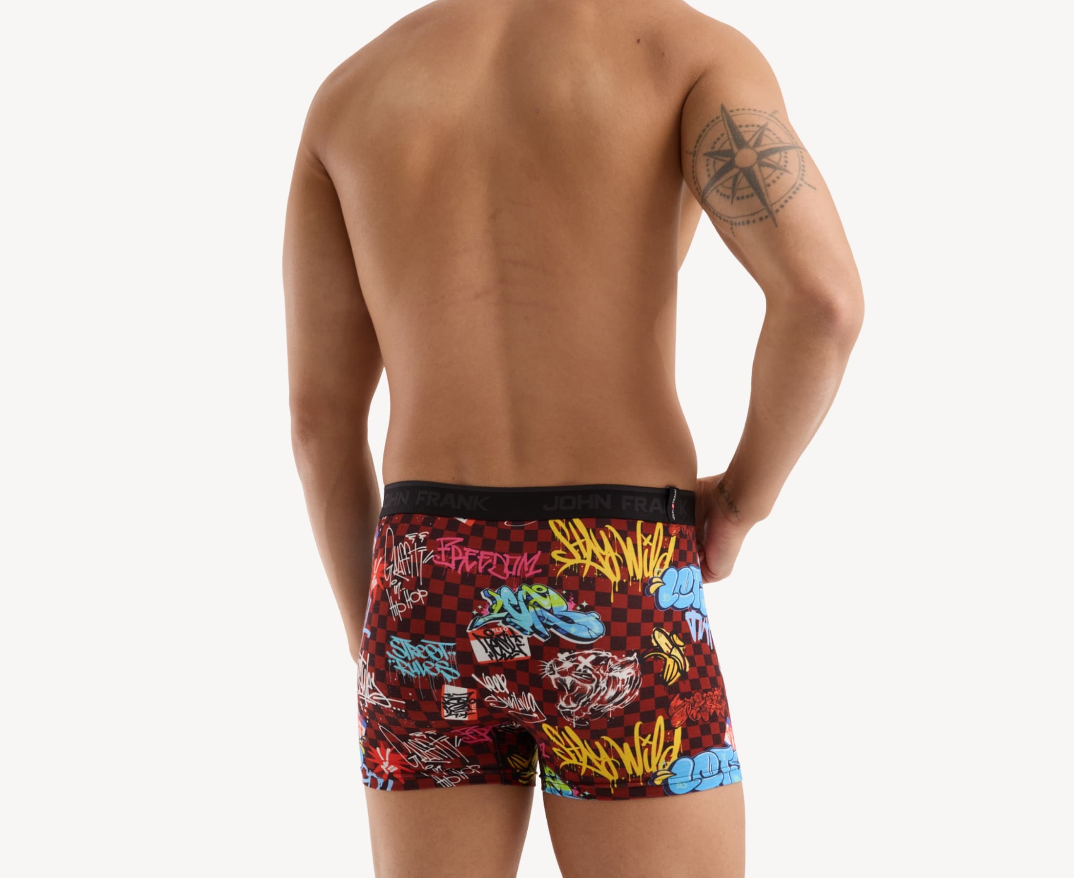 Back view of model wearing men’s 95% micromodal boxer brief in burgundy with graffiti-inspired print, smooth waistband and rear detail