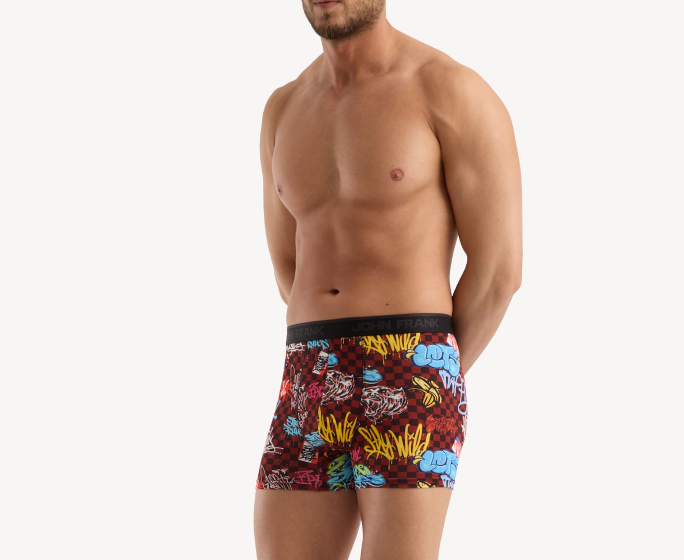 Side view of model wearing men’s 95% micromodal boxer brief in burgundy with graffiti-inspired print, contoured pouch and tailored leg cut