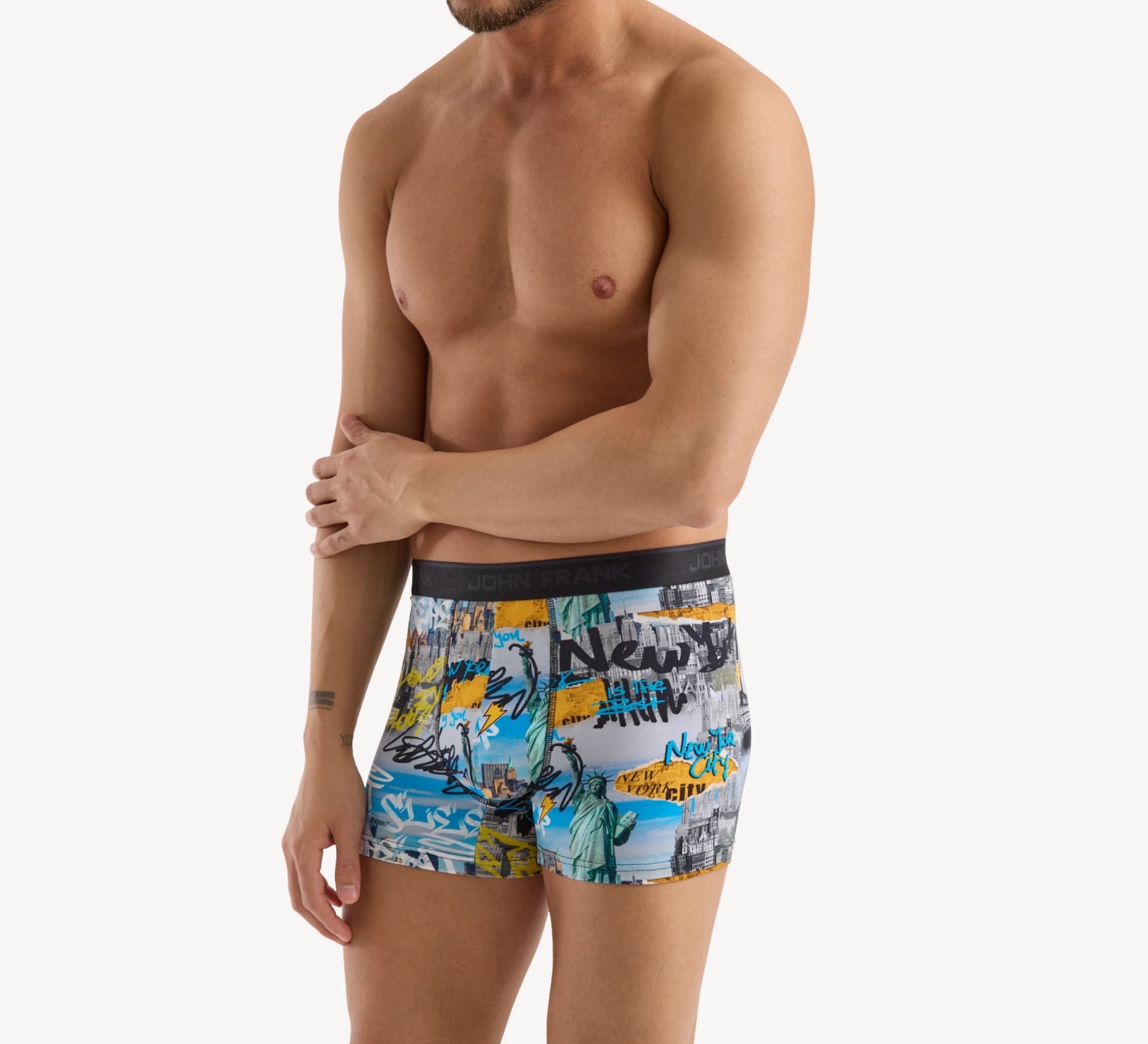 Side view of model wearing men’s 95% cotton boxer brief in multicolor NYC-inspired print with contoured pouch and tailored leg cut