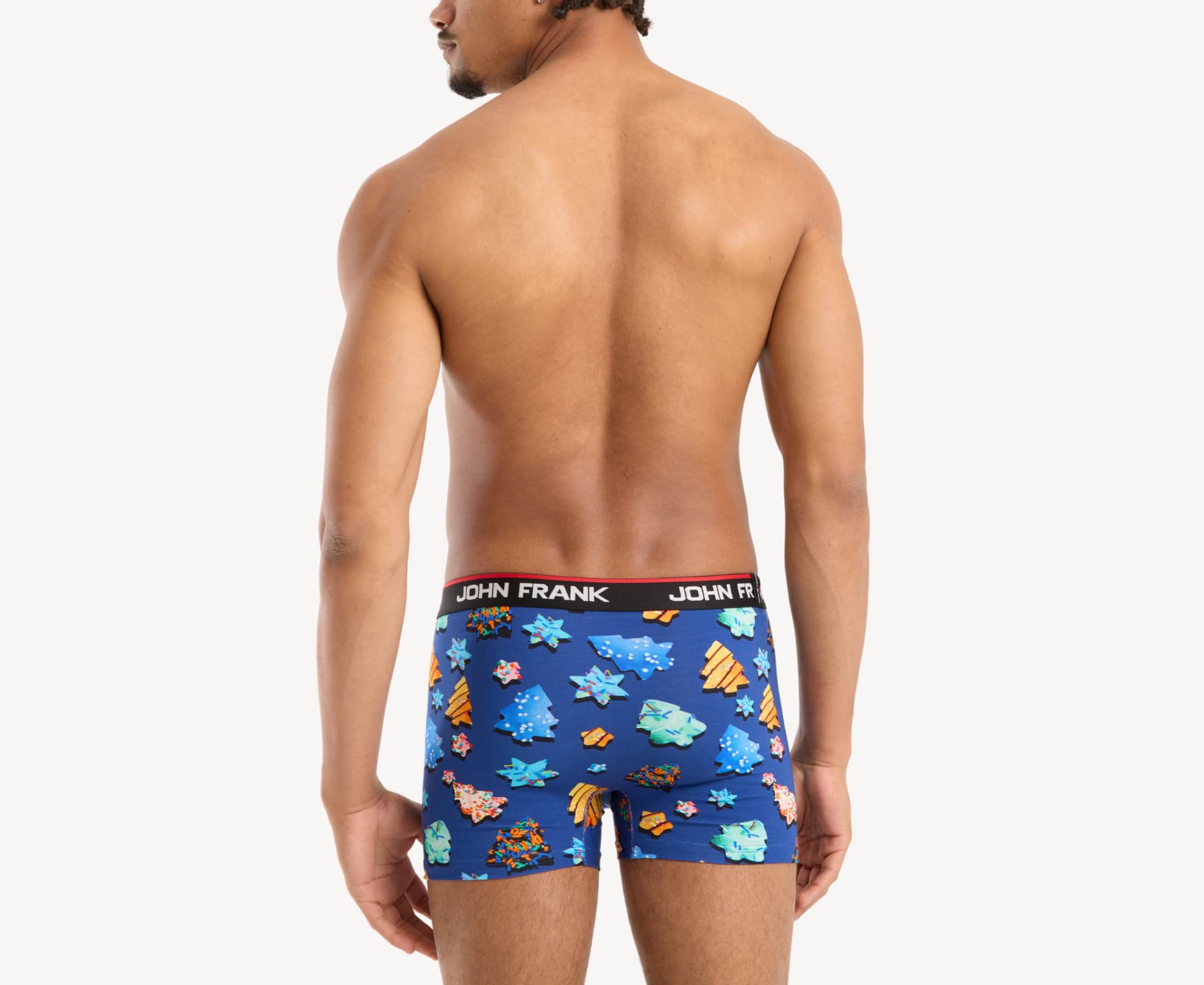Back view of male model wearing men’s 95% cotton boxer brief in royal blue with colorful sugar cookies print, showing waistband detail