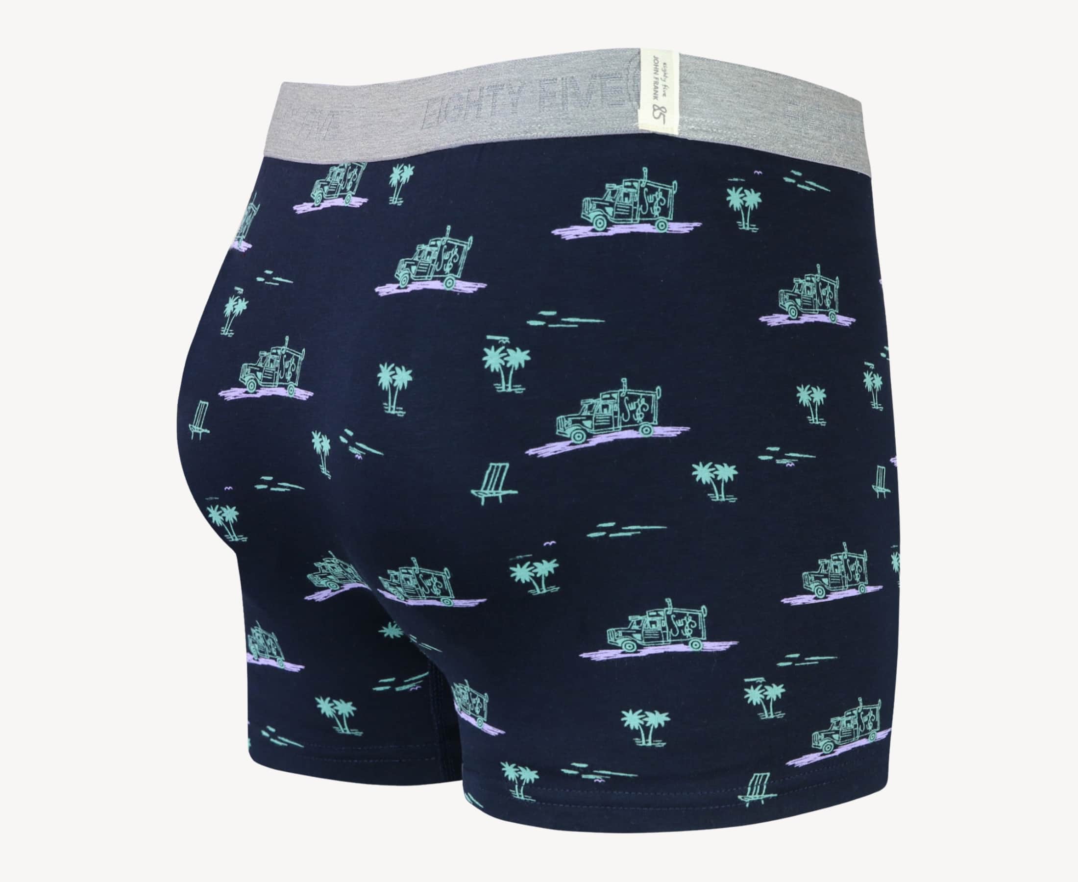 Side view of men’s 95% cotton boxer brief in black with pink surf truck and green palms print, contoured pouch, and tailored leg cut